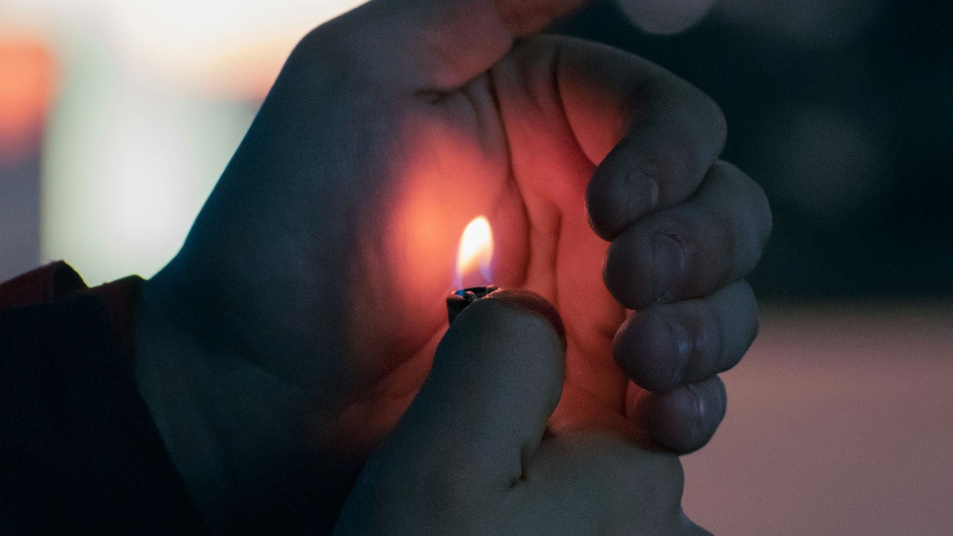 a person holding a lit candle