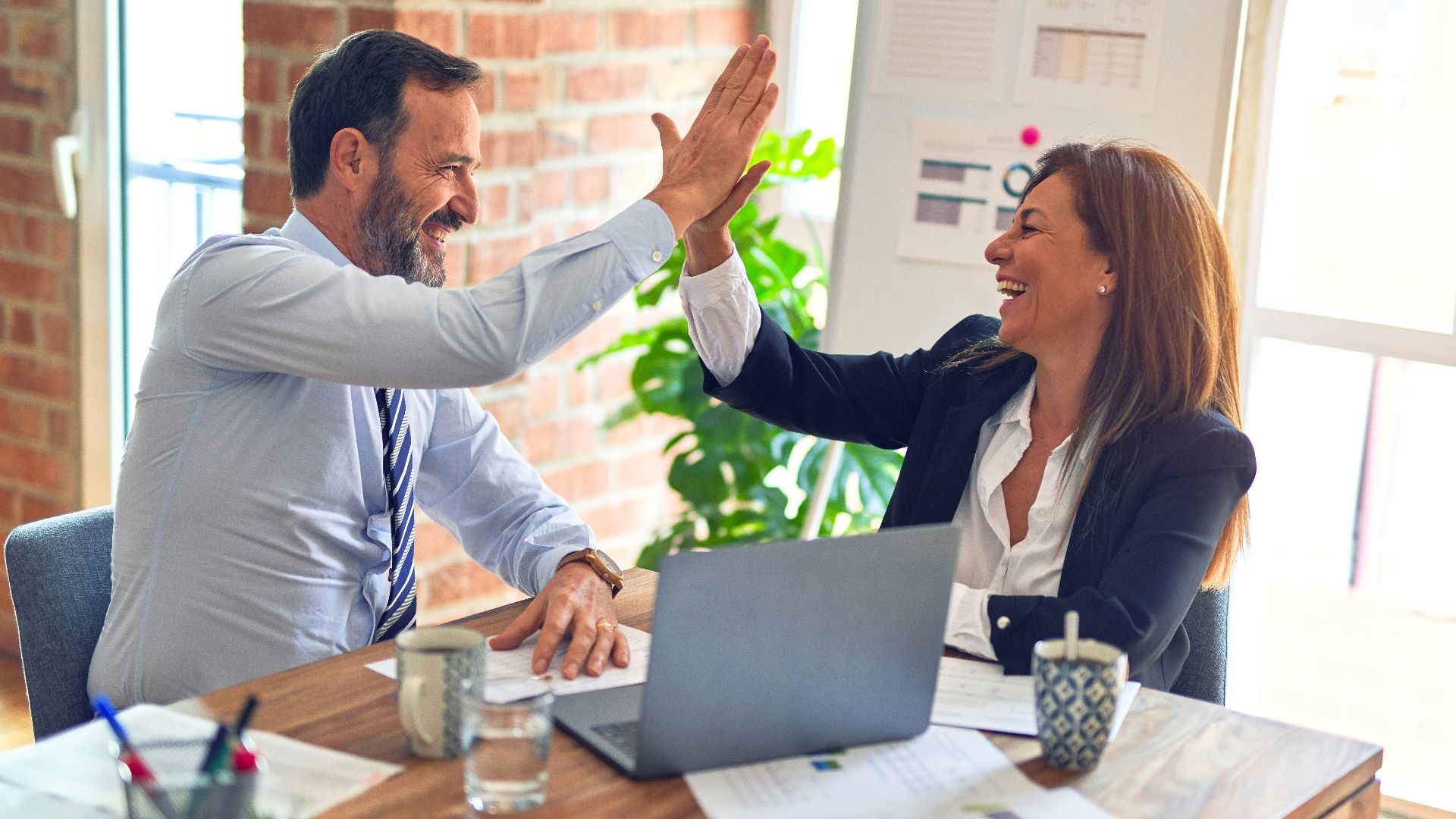 man in white dress shirt sitting beside woman in black long sleeve shirt