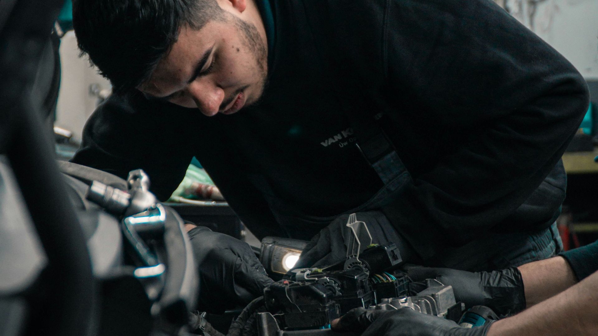 man in black jacket and blue denim jeans riding motorcycle