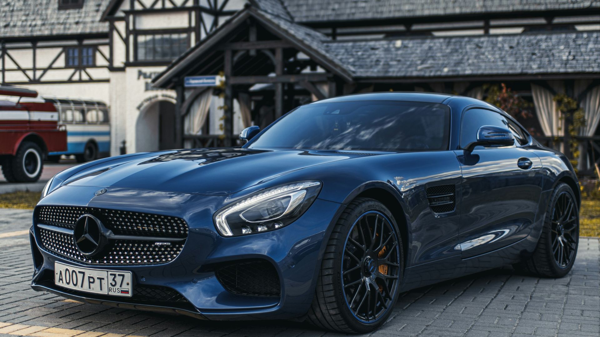 blue mercedes benz car parked near building during daytime