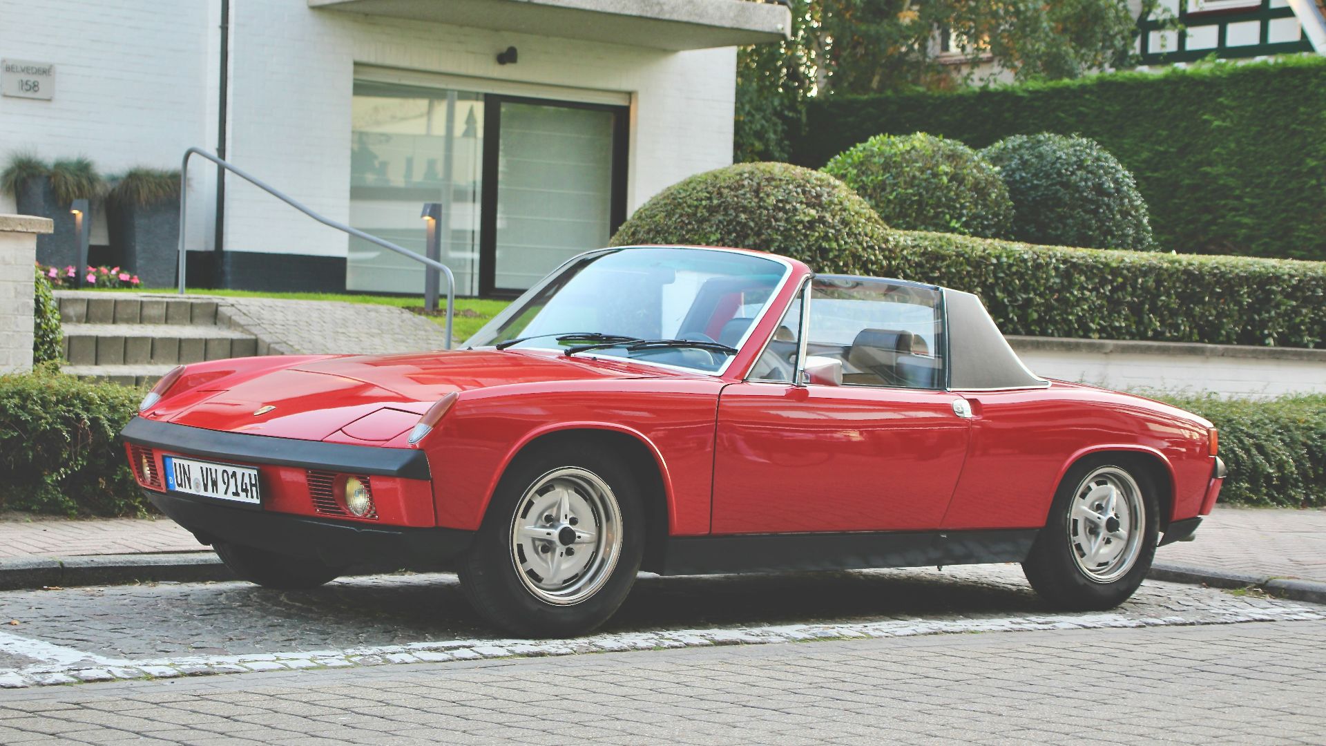 red chevrolet camaro parked on street during daytime