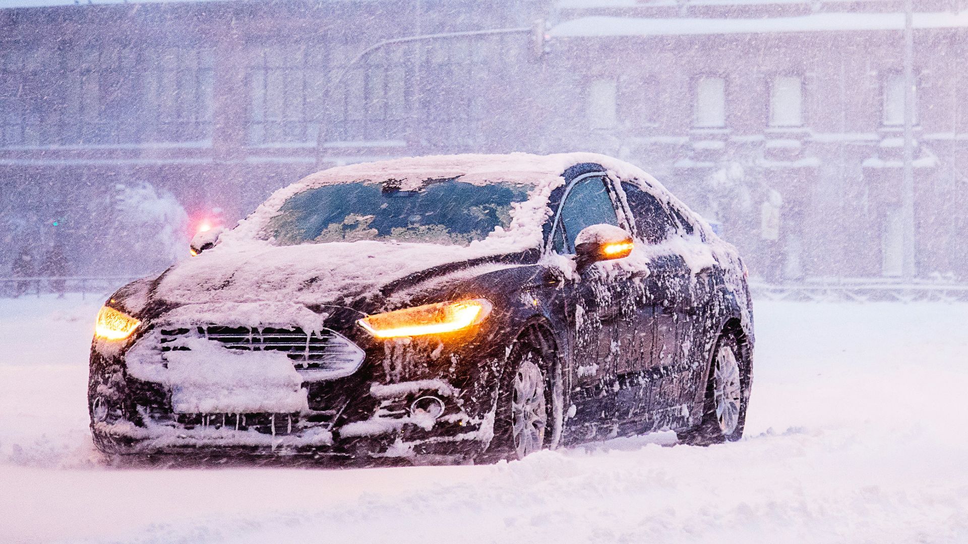 yellow and black sports car on snow covered road during daytime