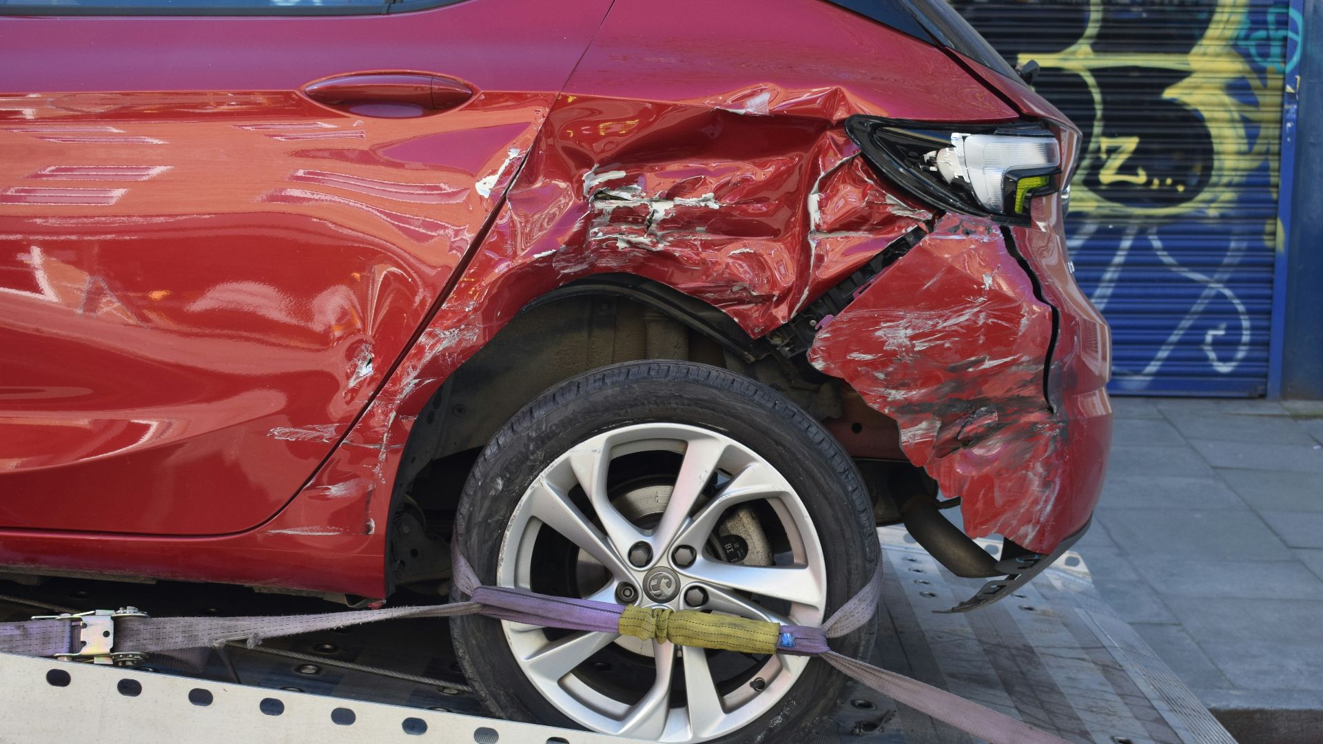 a red car is on a flatbed tow truck
