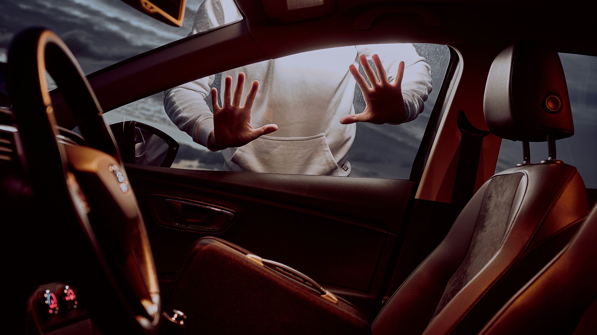 man in white long sleeve shirt driving car