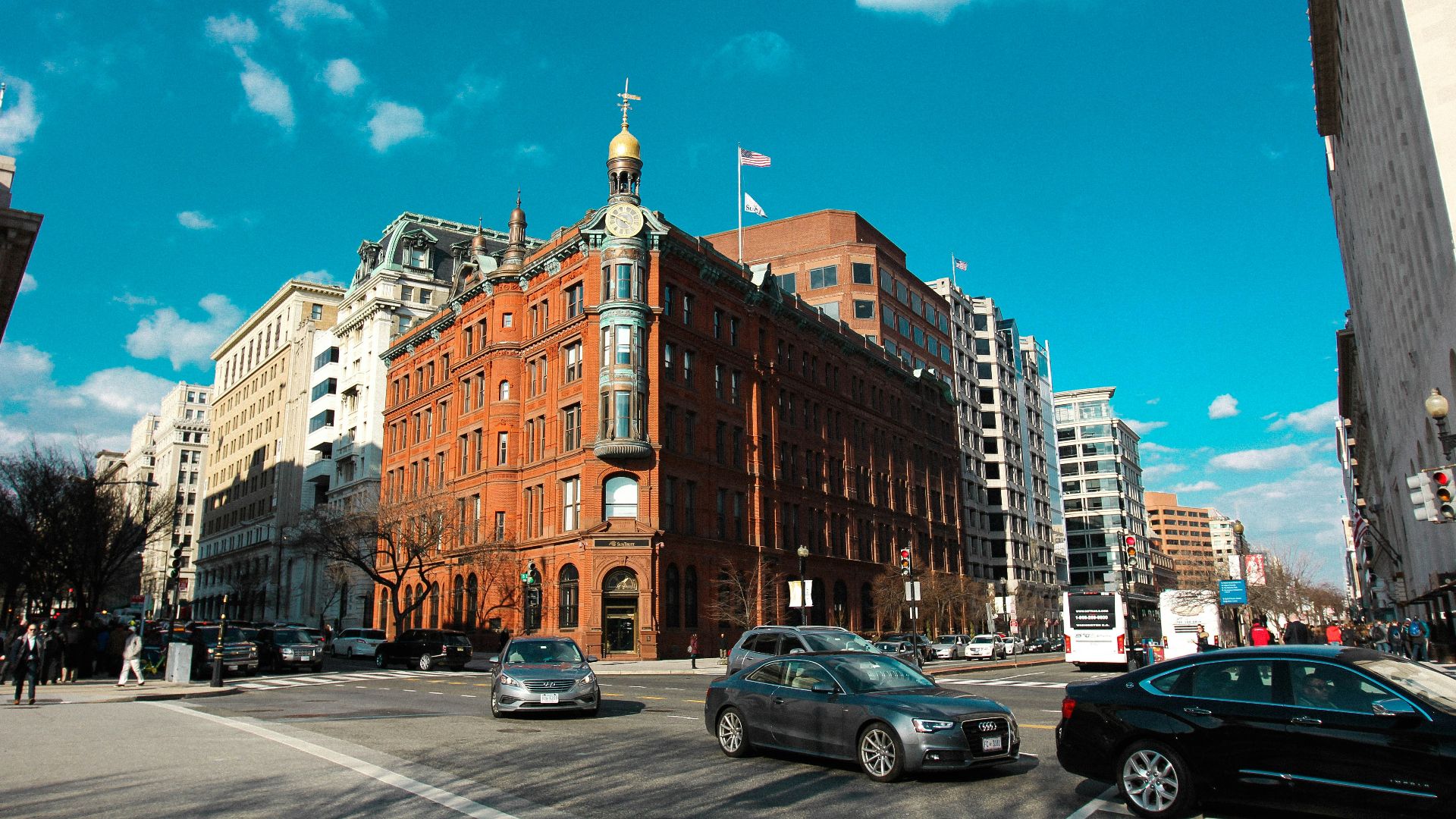 brown high-rise building near the road with cars