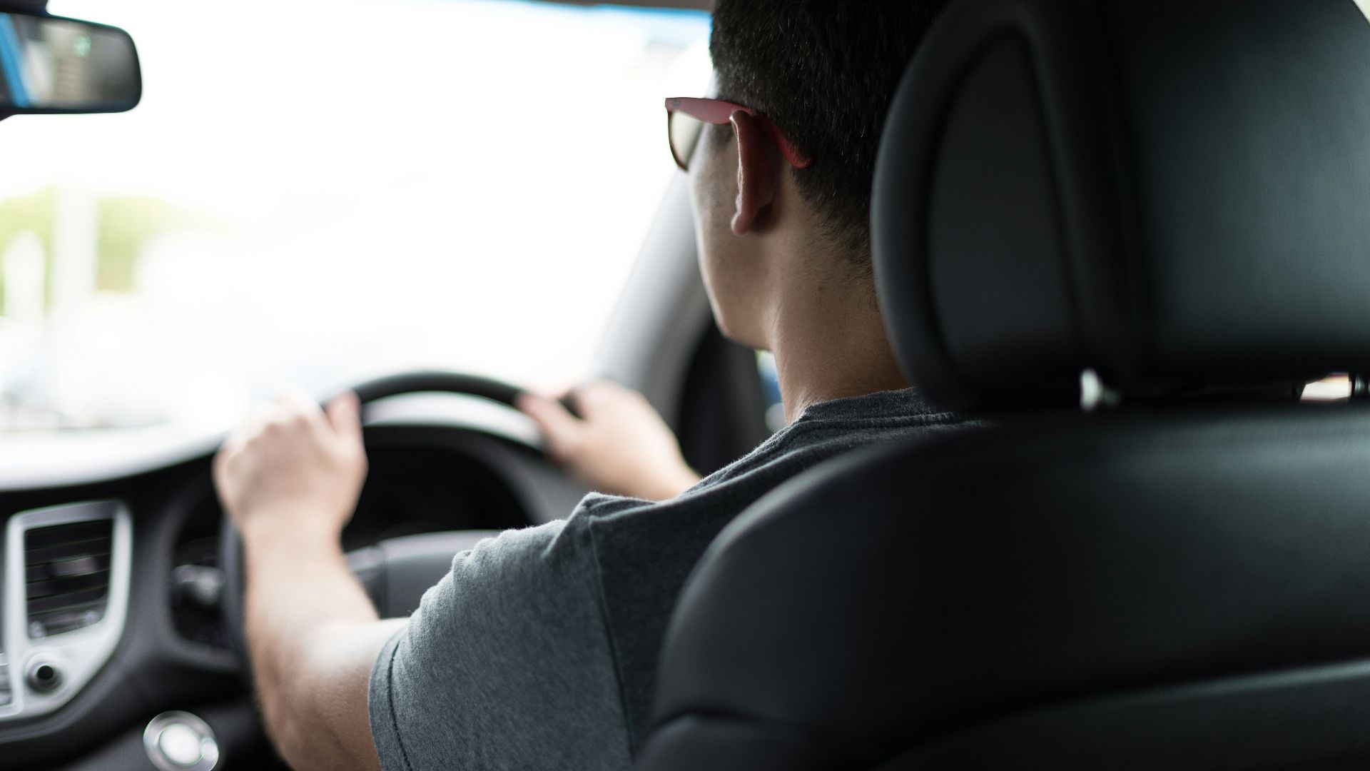 man driving car during daytime