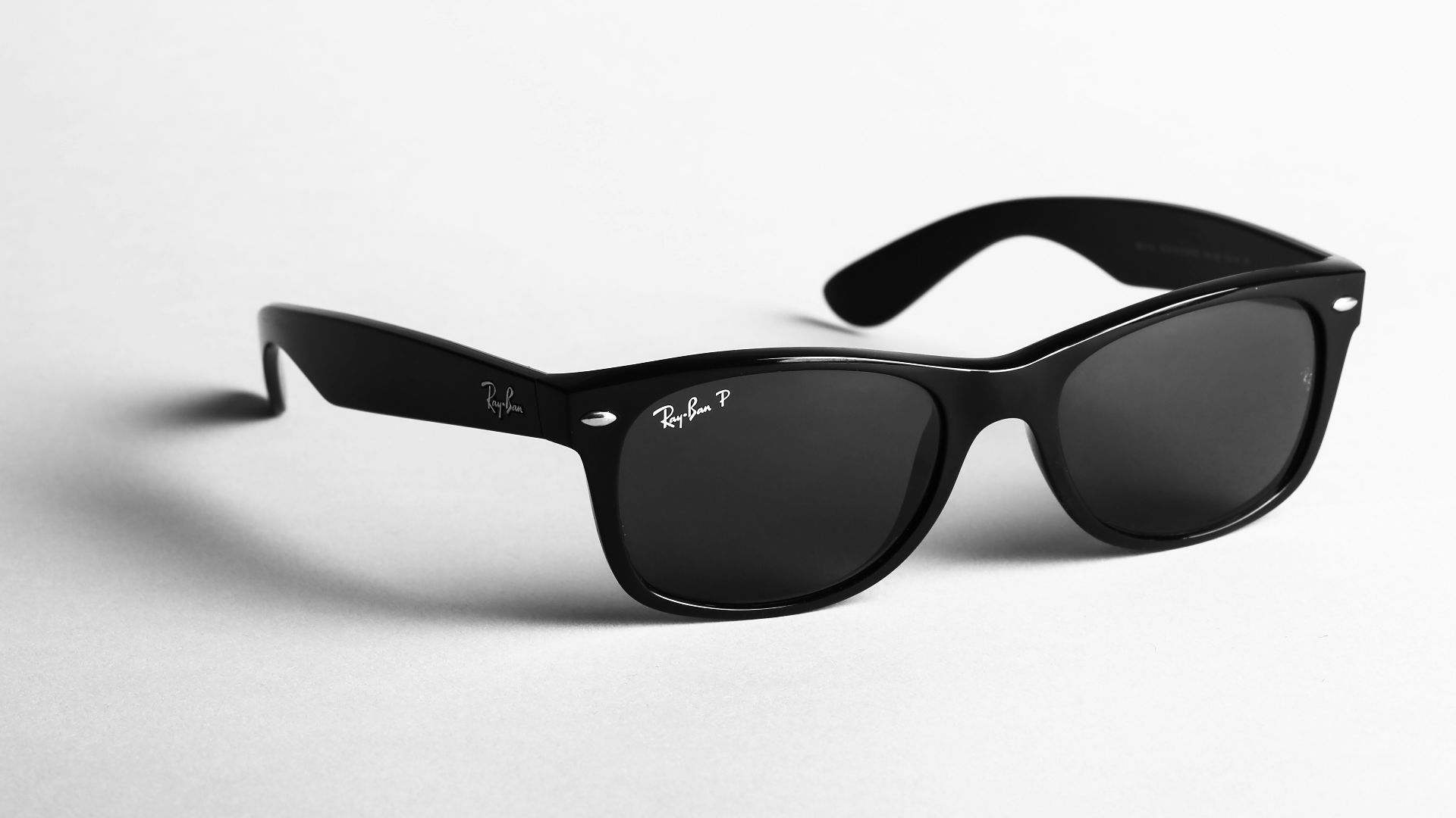shallow focus photo of black Ray-Ban wayfarer sunglasses