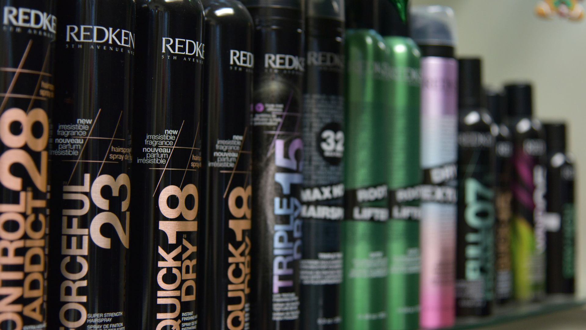 a row of redkenn hair products on a shelf