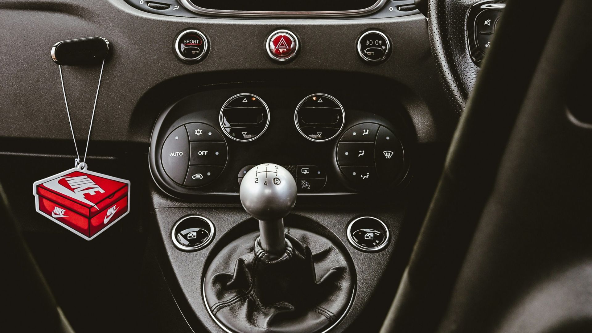 The dashboard of a car with a camera mounted to it's side