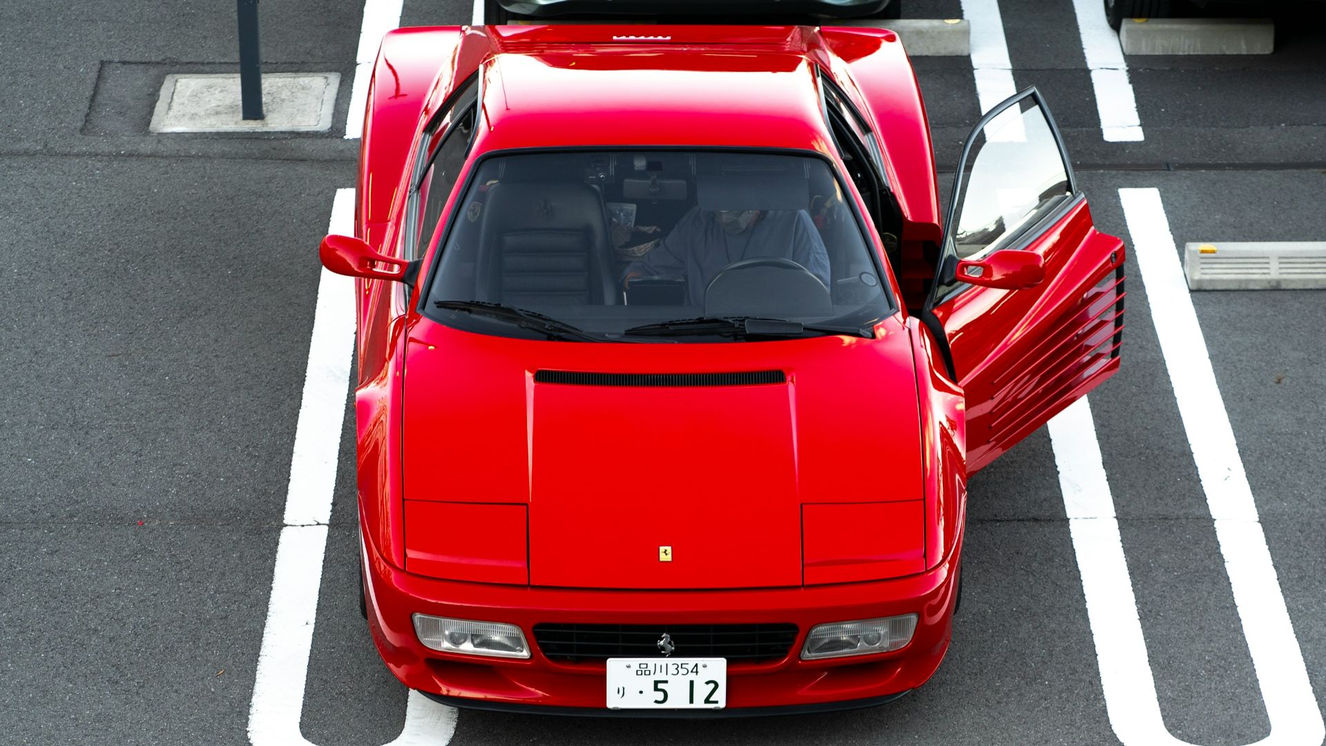 A red sports car parked in a parking space