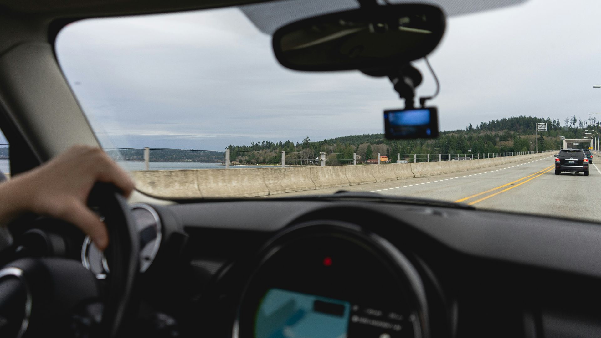 a person driving a car on a highway