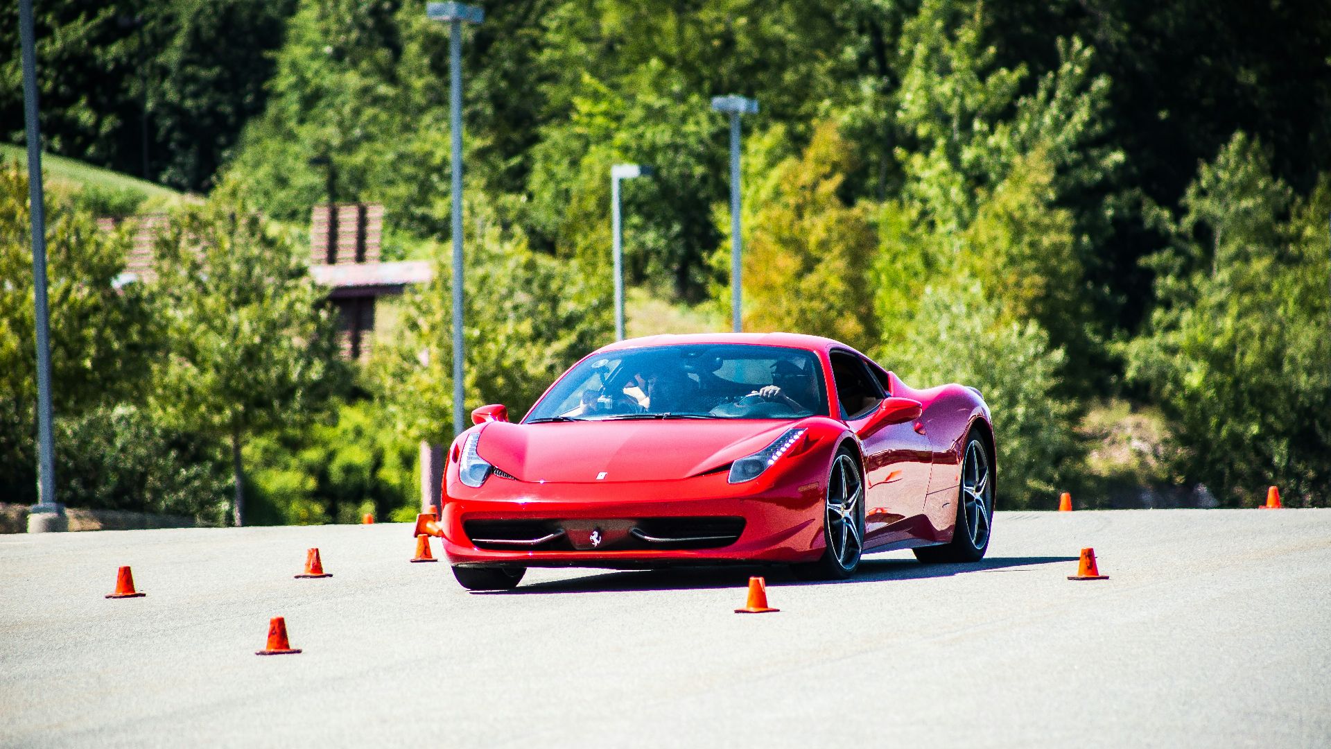 red coupe on gray asphalt during daytime