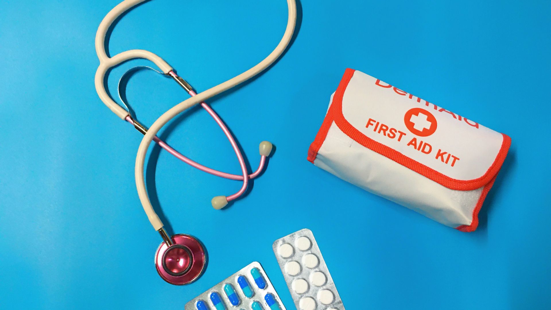 a bag of pills, a stethoscope, and a first aid kit