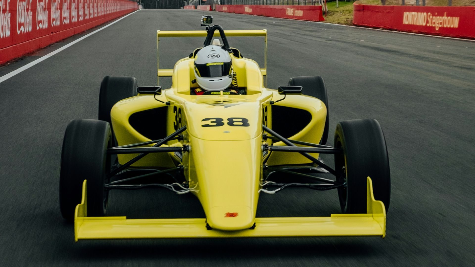yellow and black f 1 car on road during daytime
