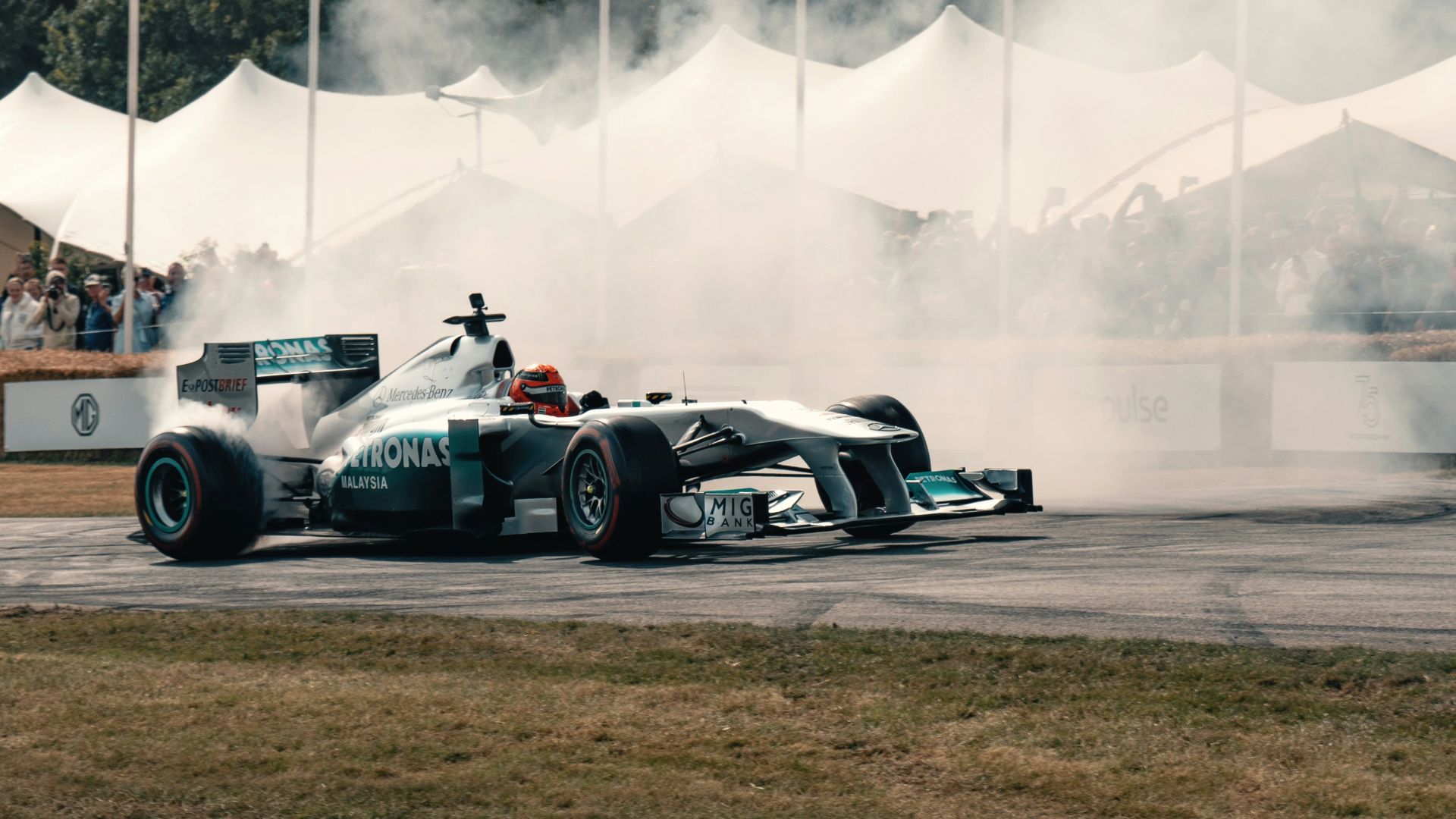 A man driving a race car on top of a race track
