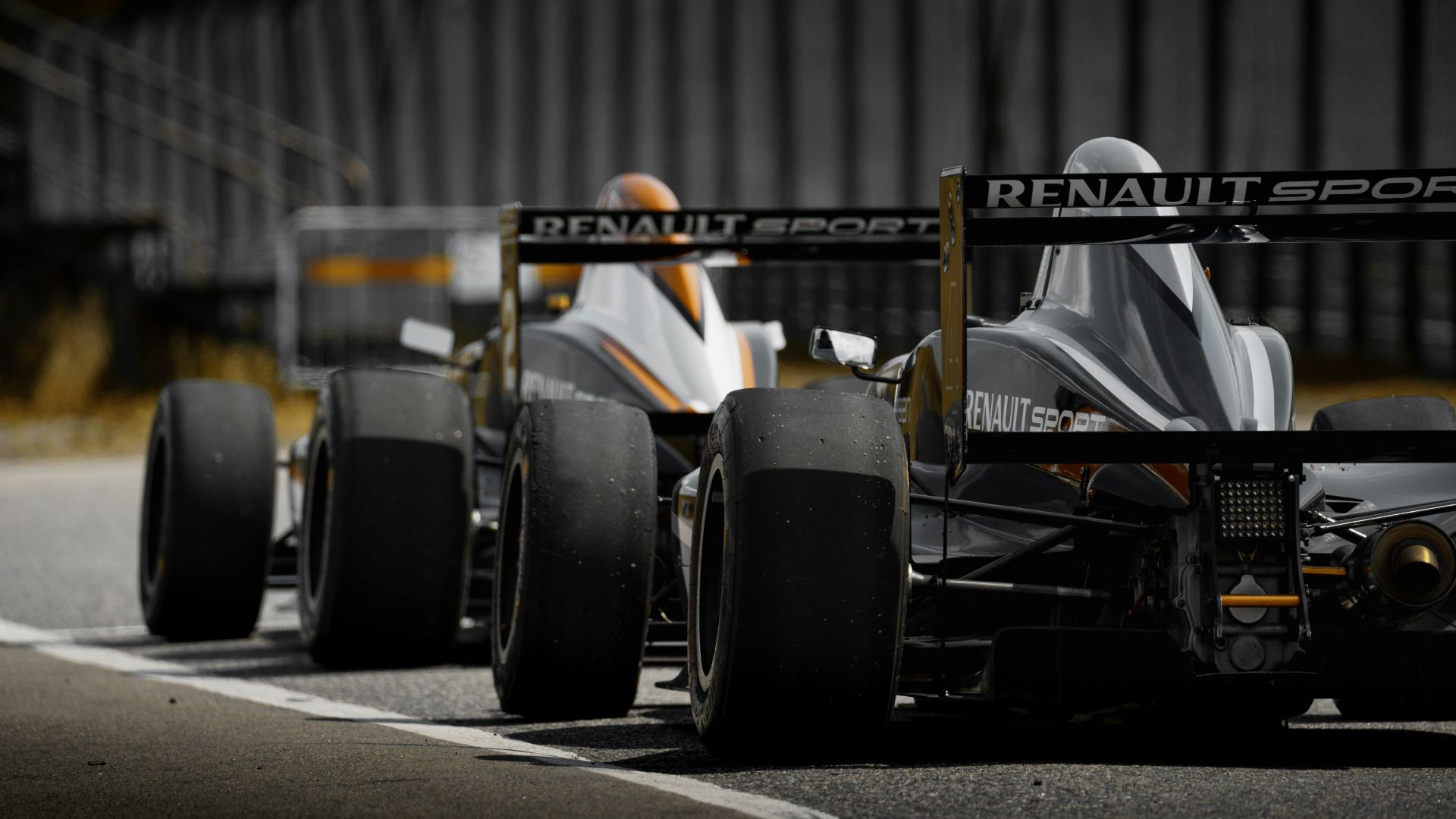black and yellow f 1 car on road during daytime