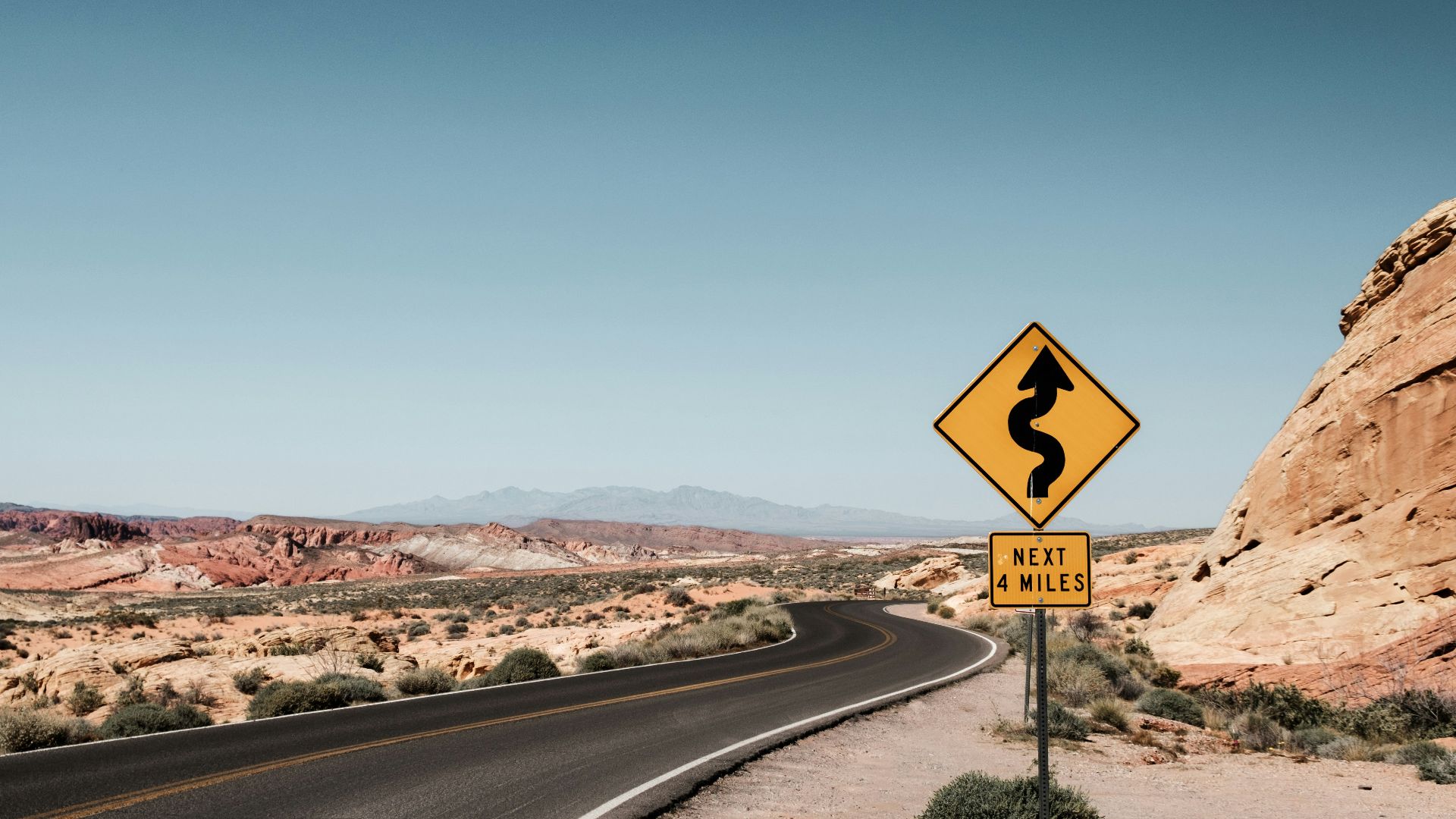 yellow and black zigzag signage