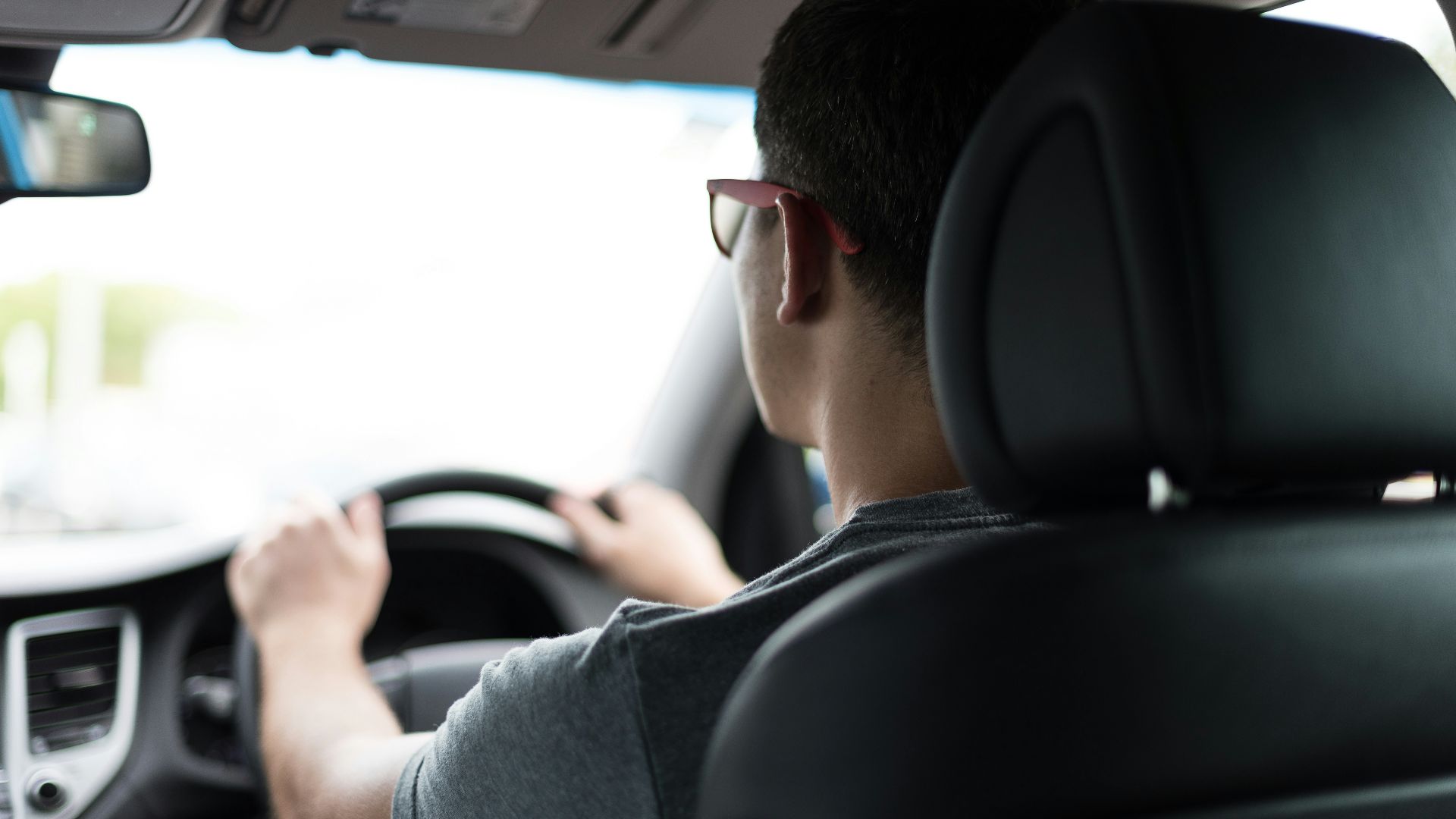 man driving car during daytime