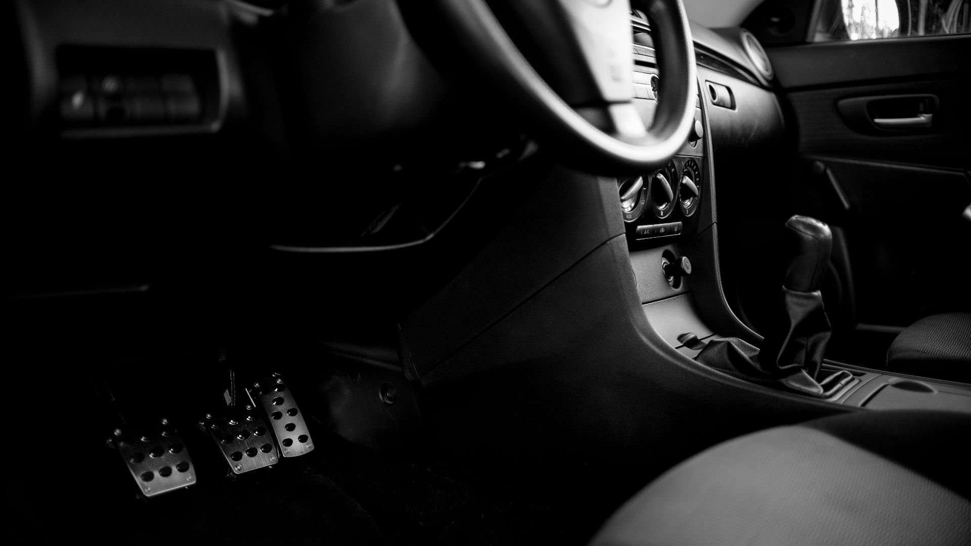 a black and white photo of the inside of a car