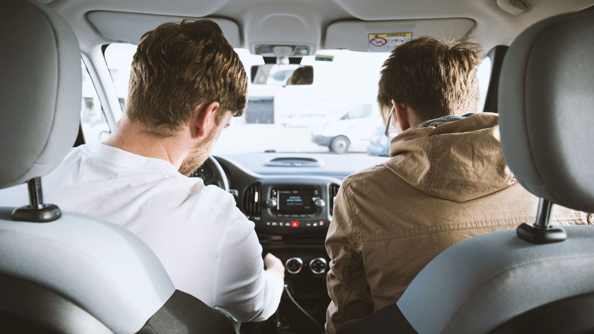 two men sitting inside vehicle