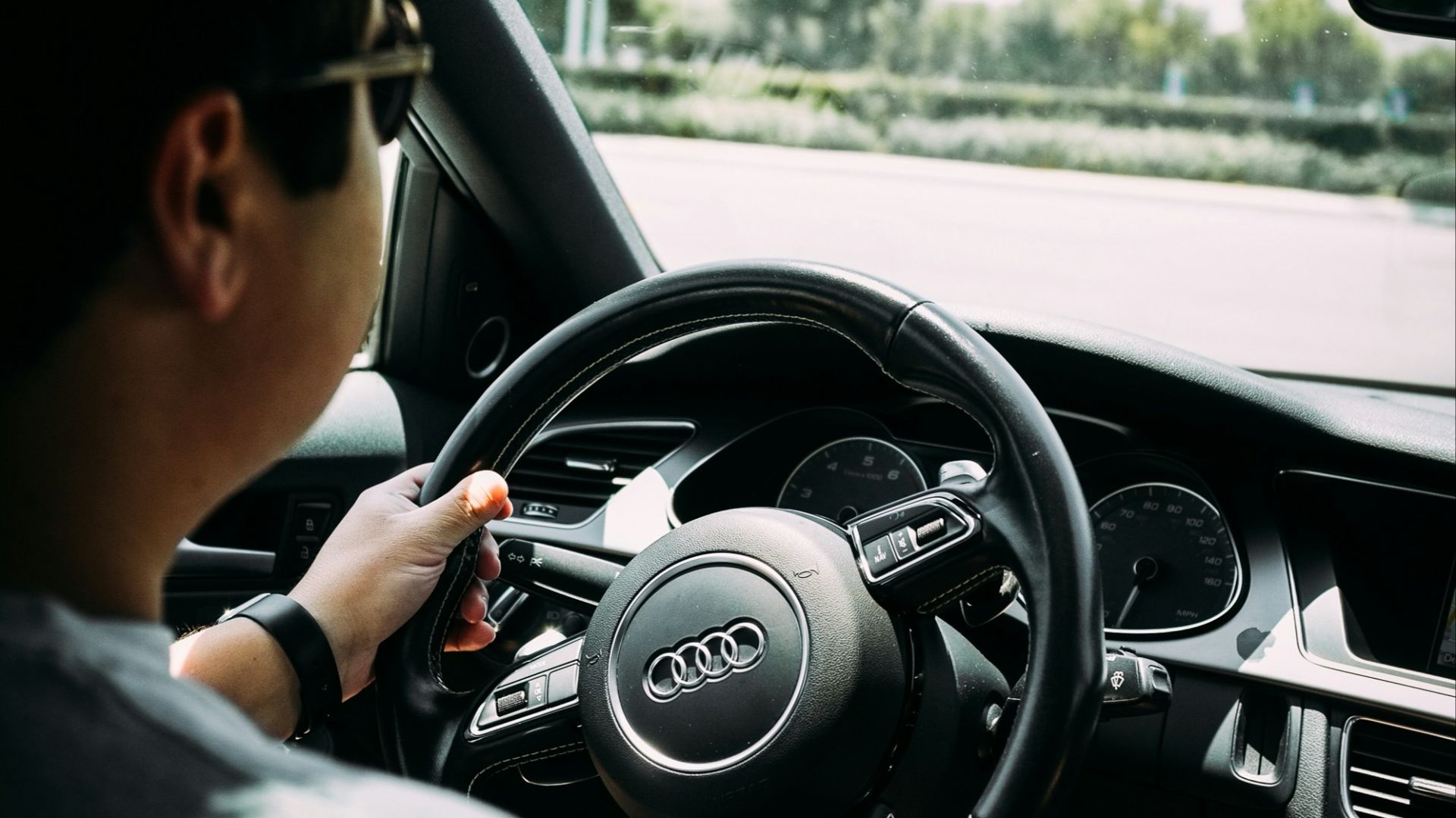man driving an Audi car