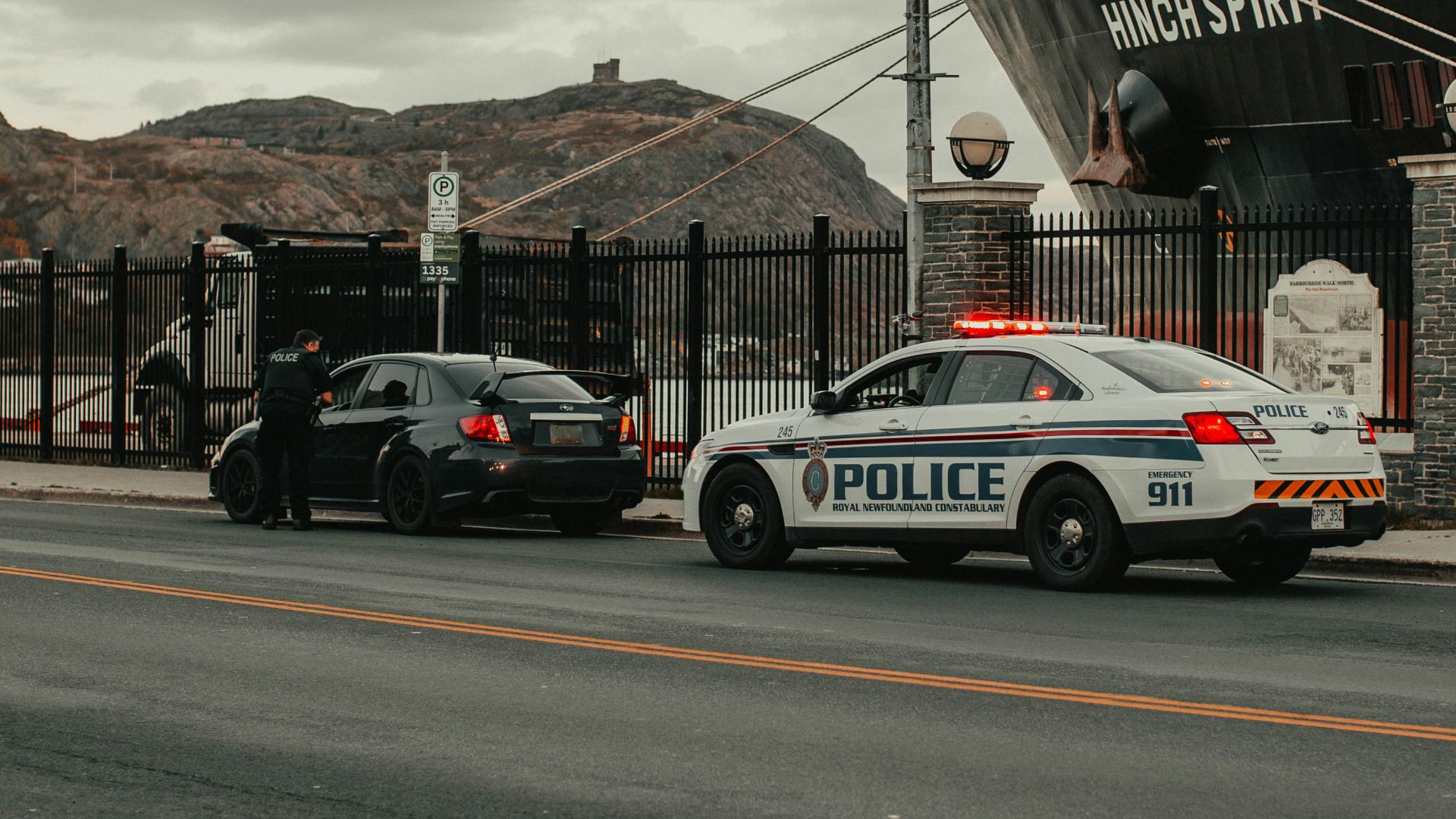white and blue police car on road