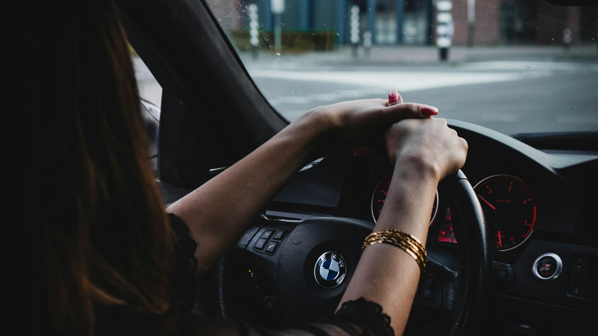 woman inside BMW car holding steering wheel