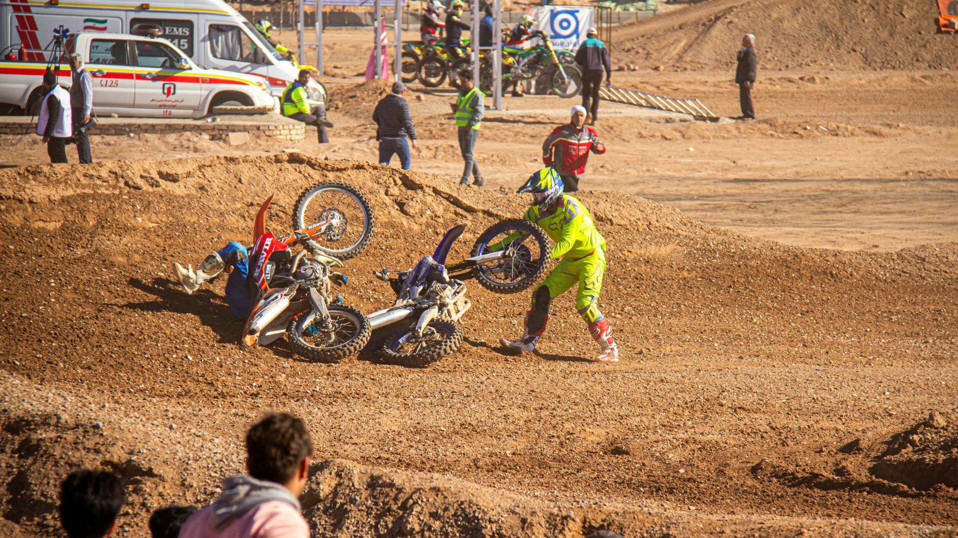 girl in red jacket and green pants riding motocross dirt bike