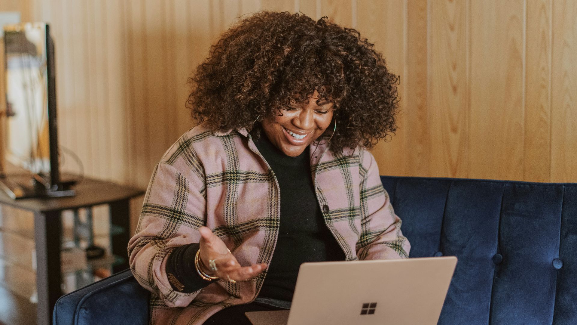 person sitting on couch holding a Surface device