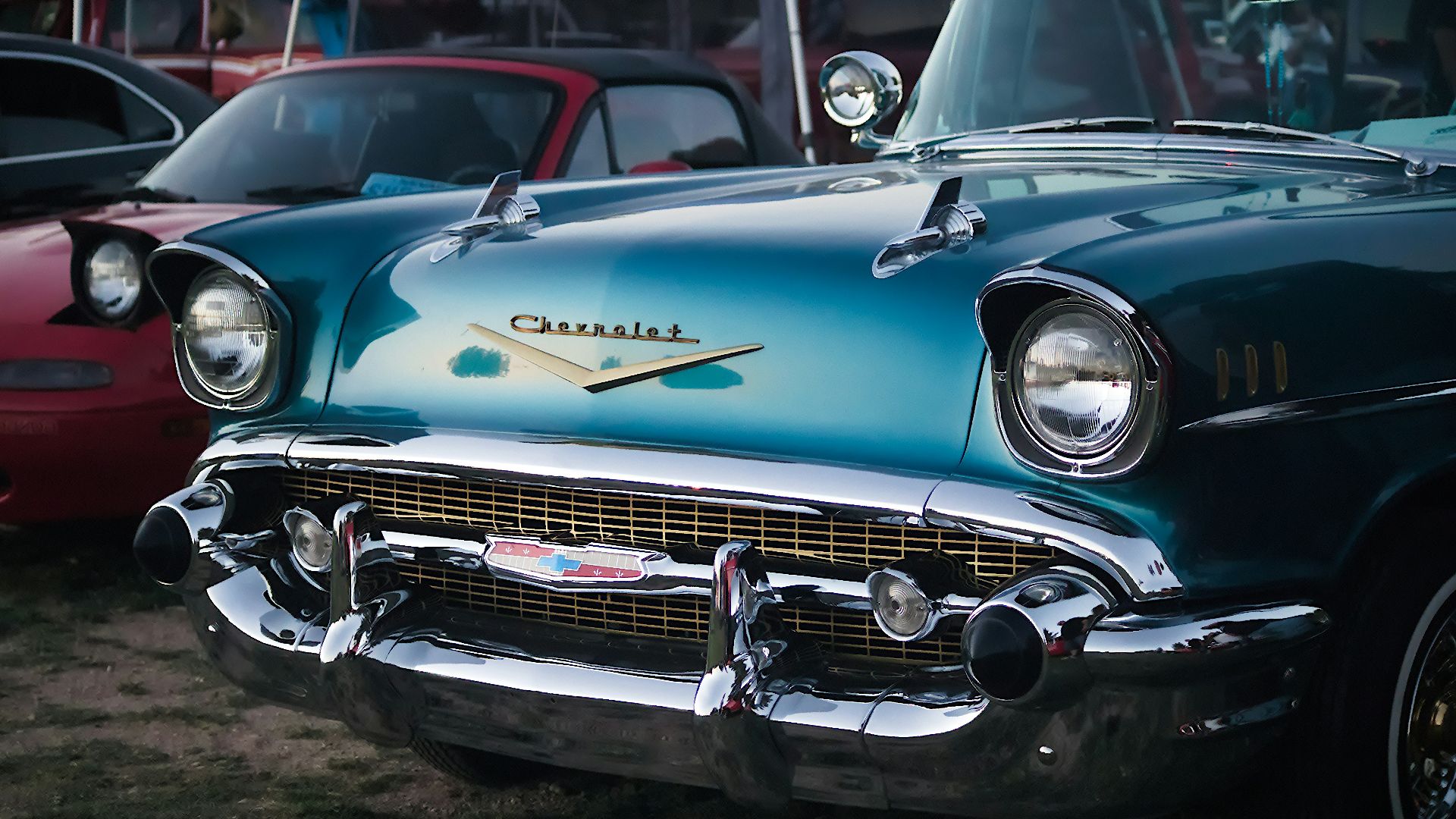 blue classic car parked on gray asphalt road during daytime