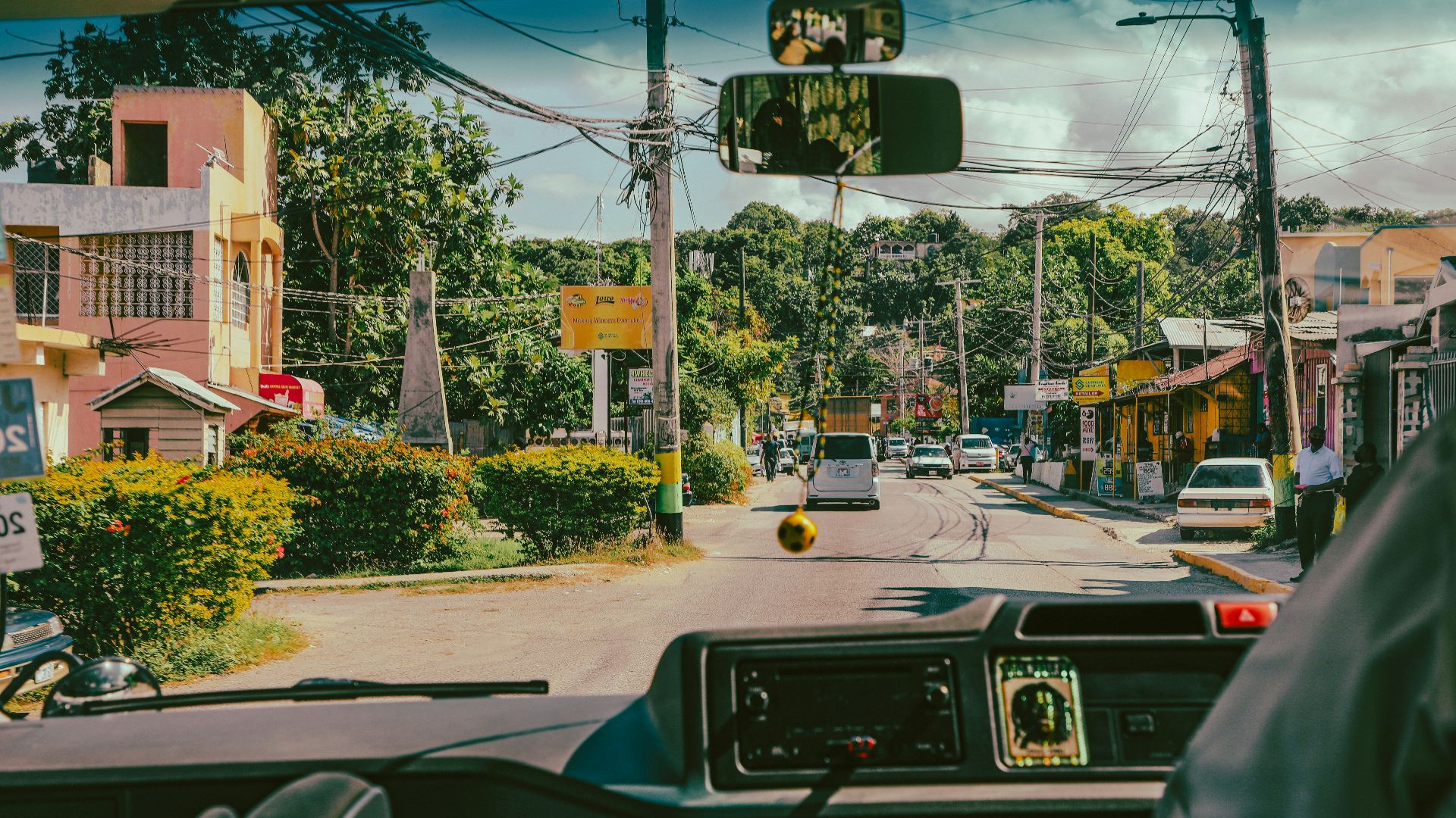 a view of a street from inside a vehicle