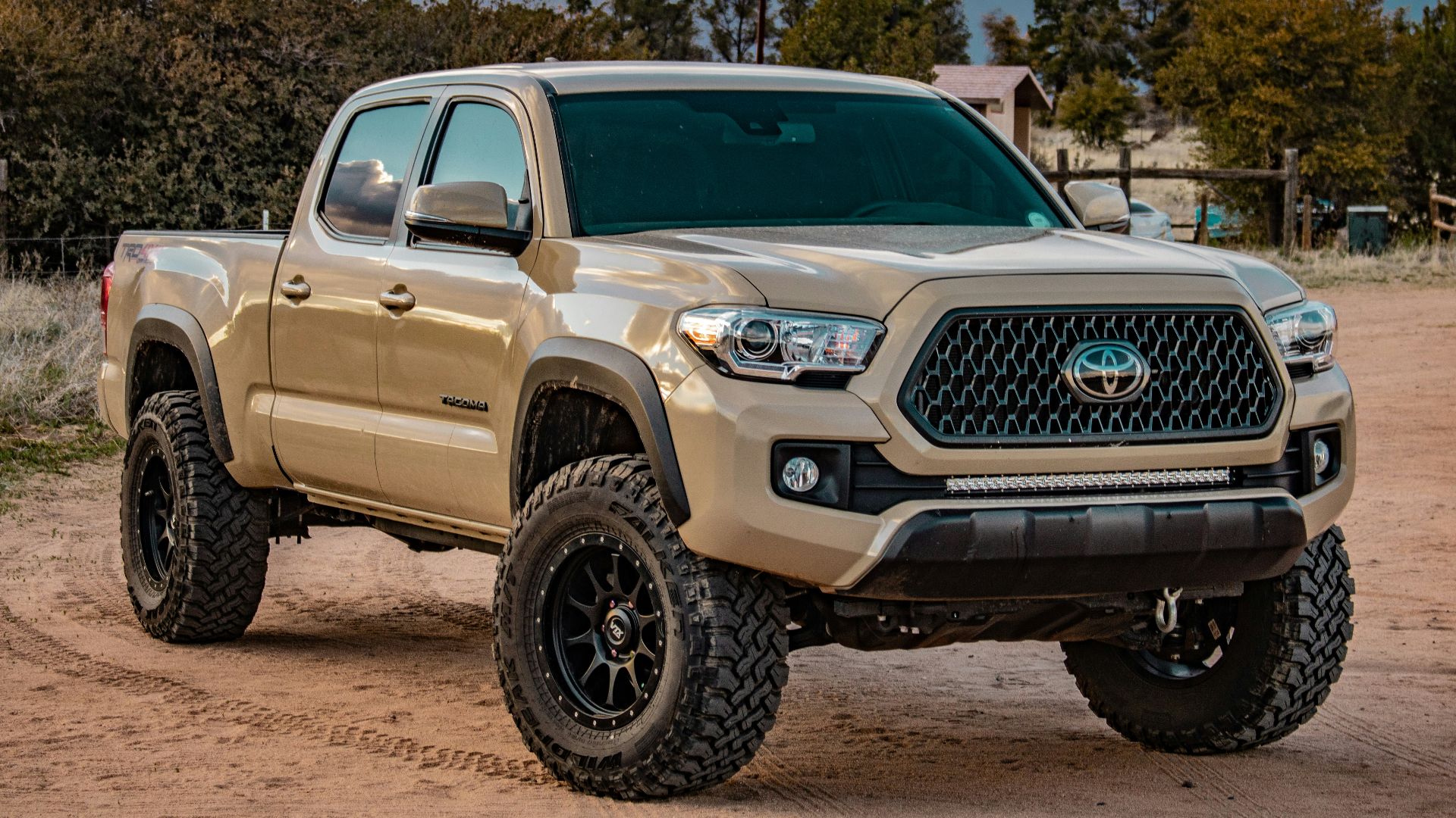 white Toyota crew cab pickup truck on ground