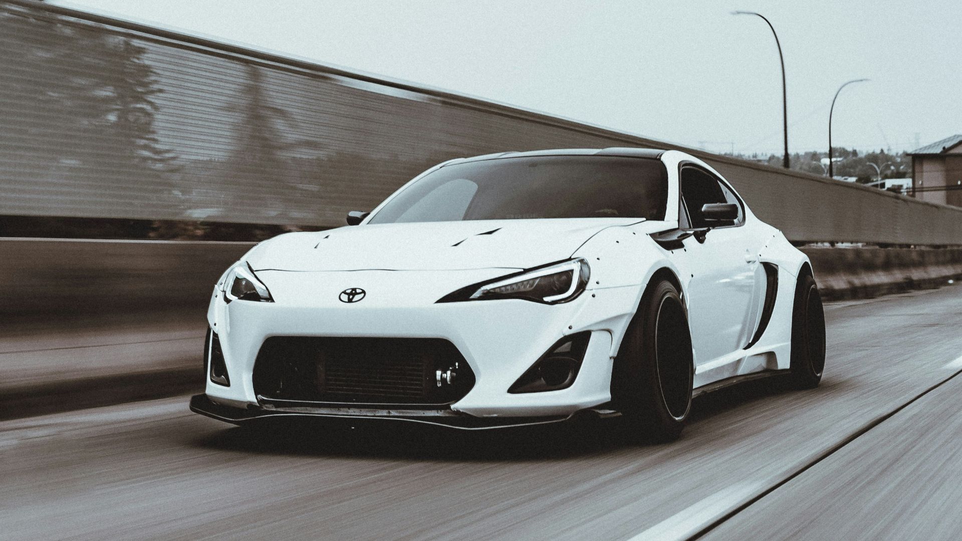 white porsche 911 on gray pavement