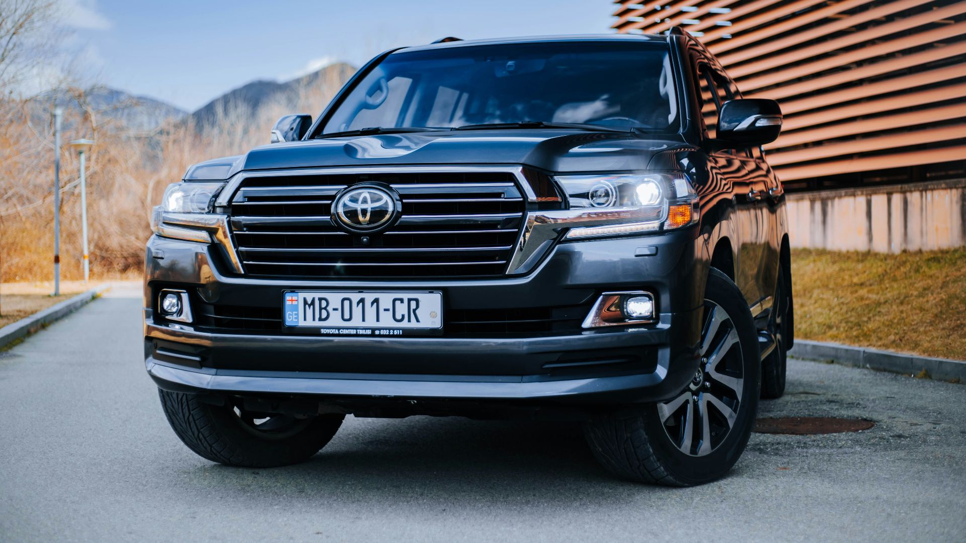 a black toyota land cruiser parked in front of a building