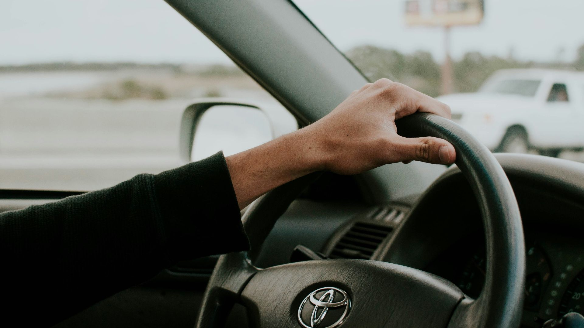 person driving Toyota car