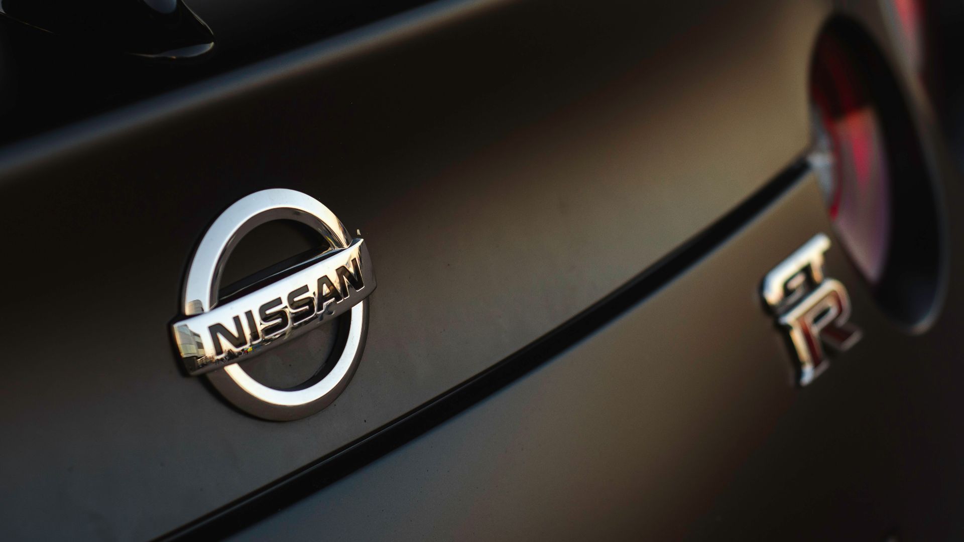 a close up of a nissan emblem on a car