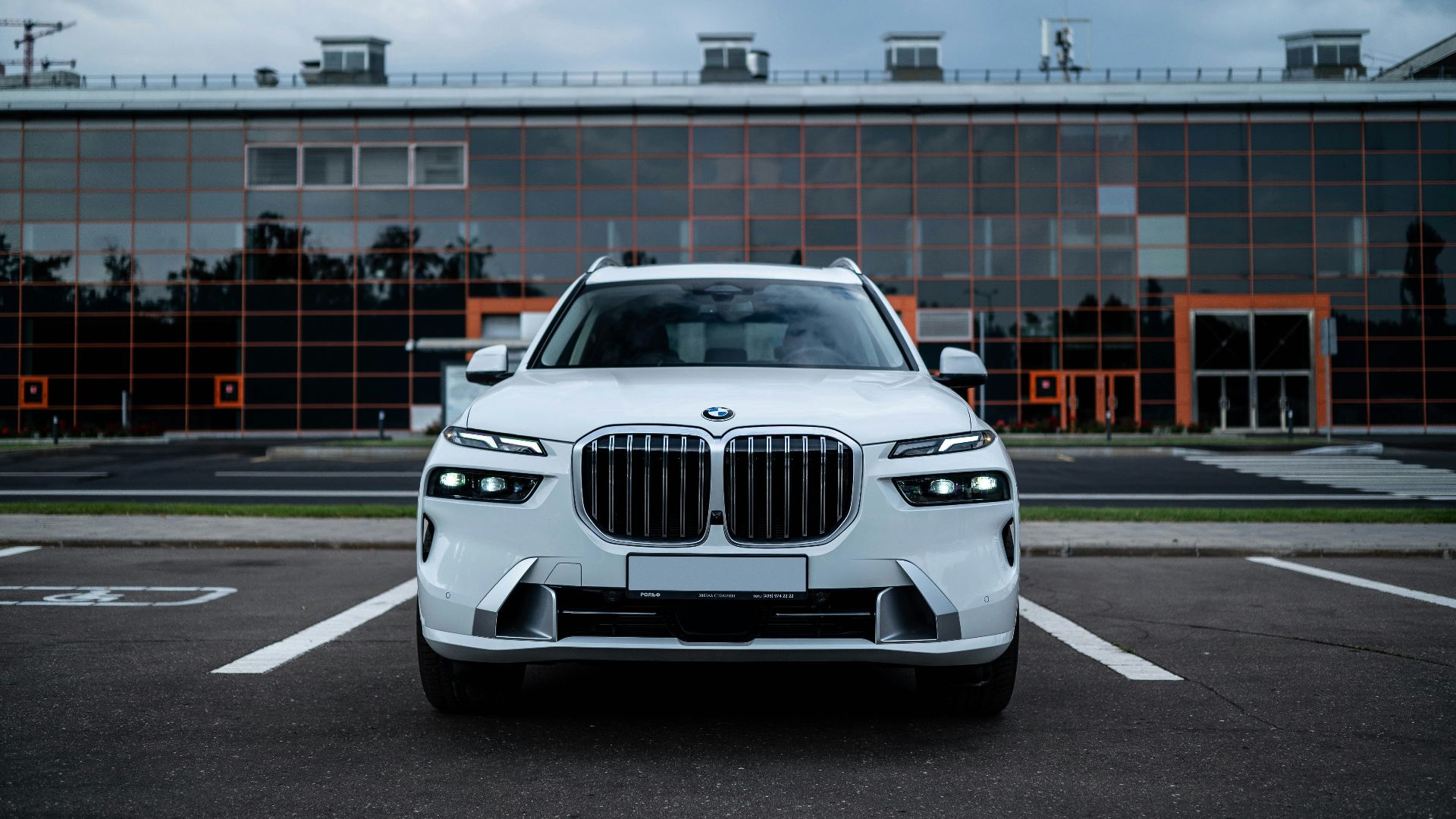 a white bmw suv parked in a parking lot