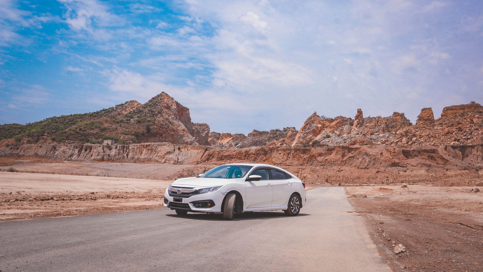 a white car parked on the side of a road