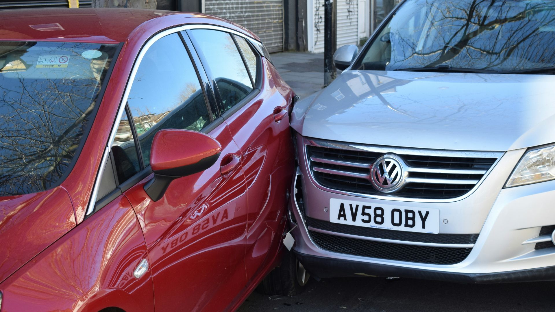 two cars parked next to each other in a parking lot