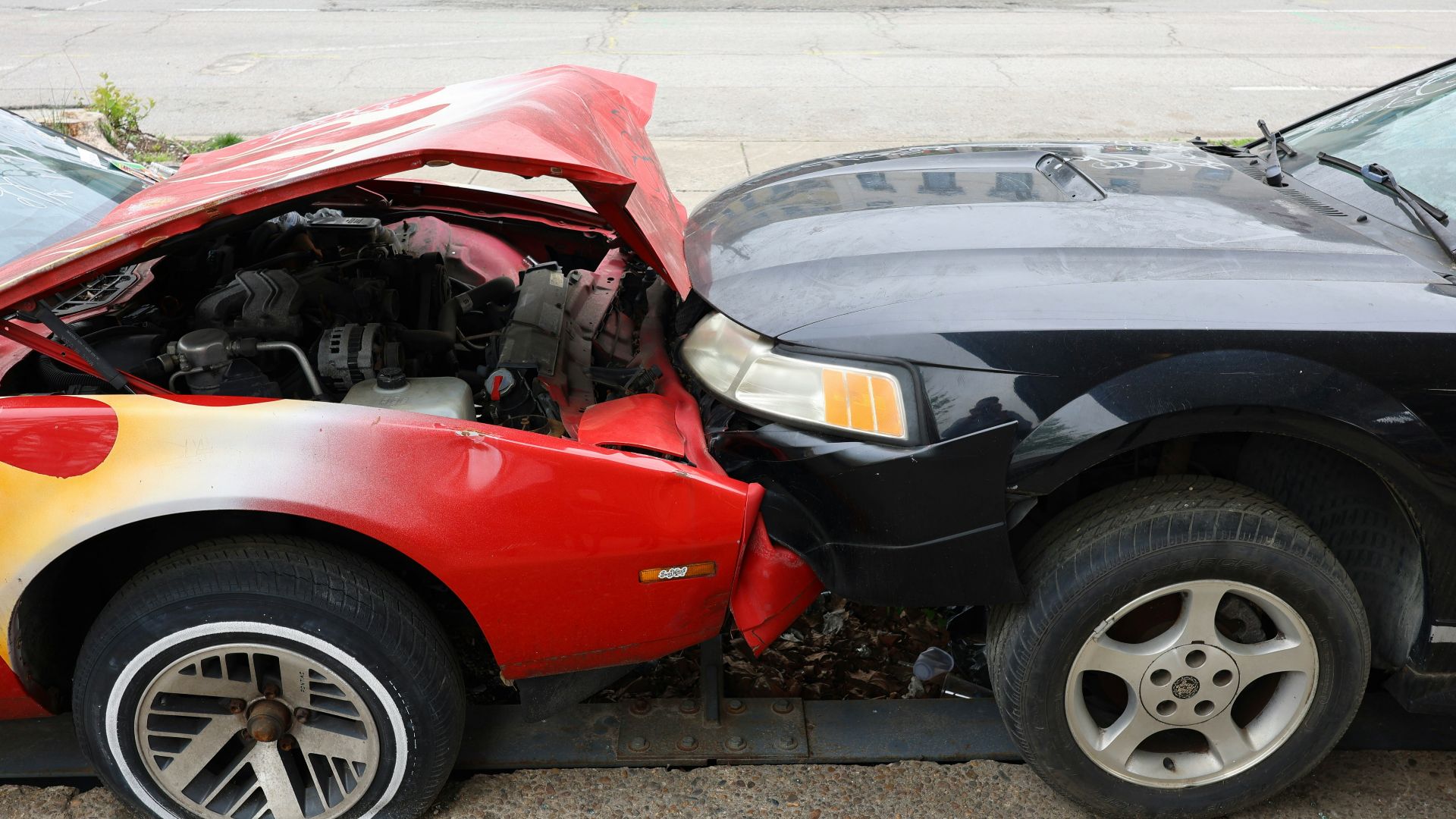 Cars are involved in a frontal collision.