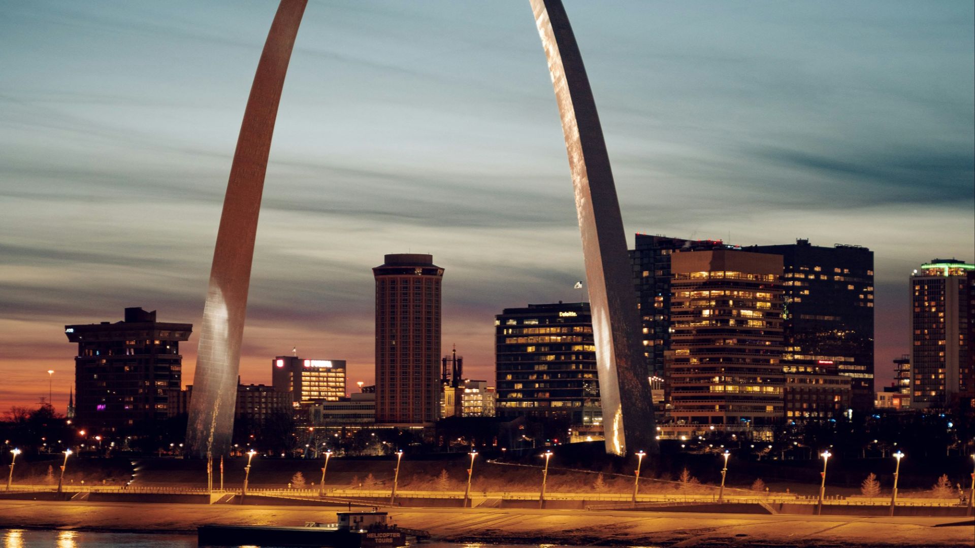 the st louis arch is lit up at night