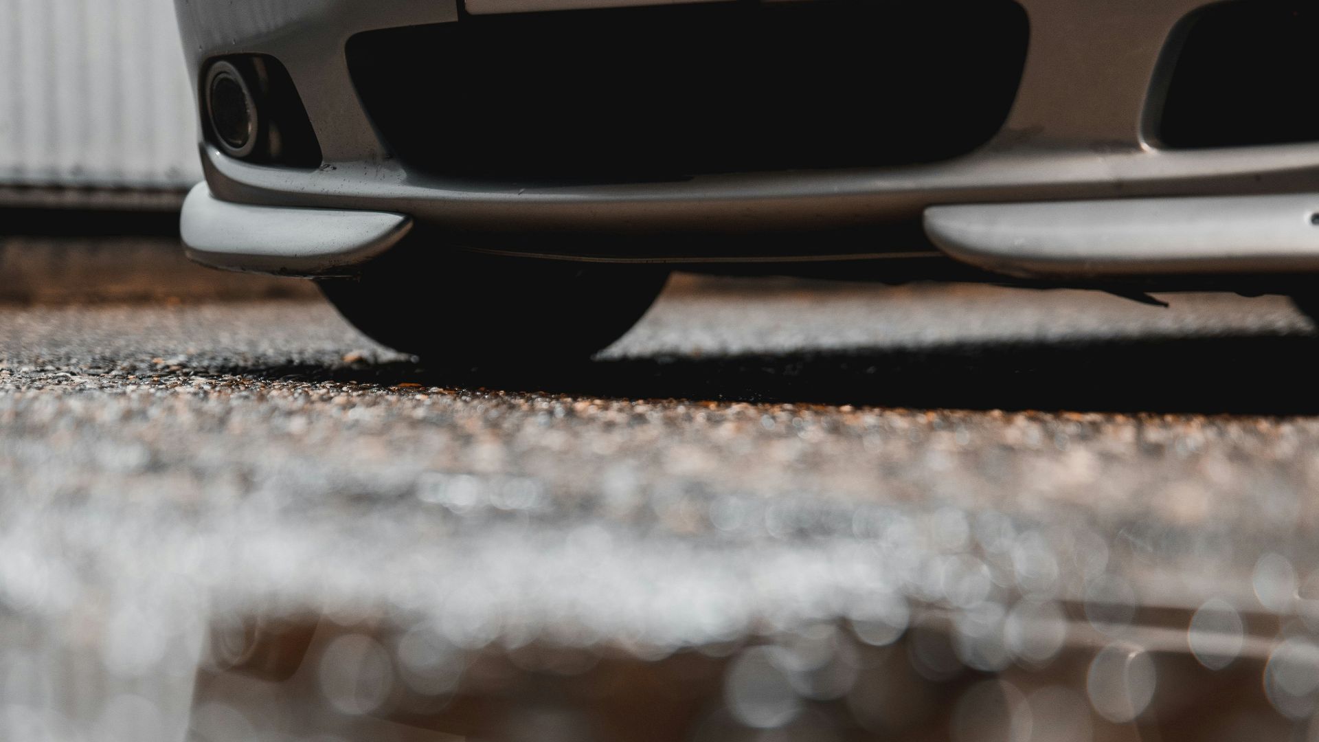 a silver car parked in front of a building
