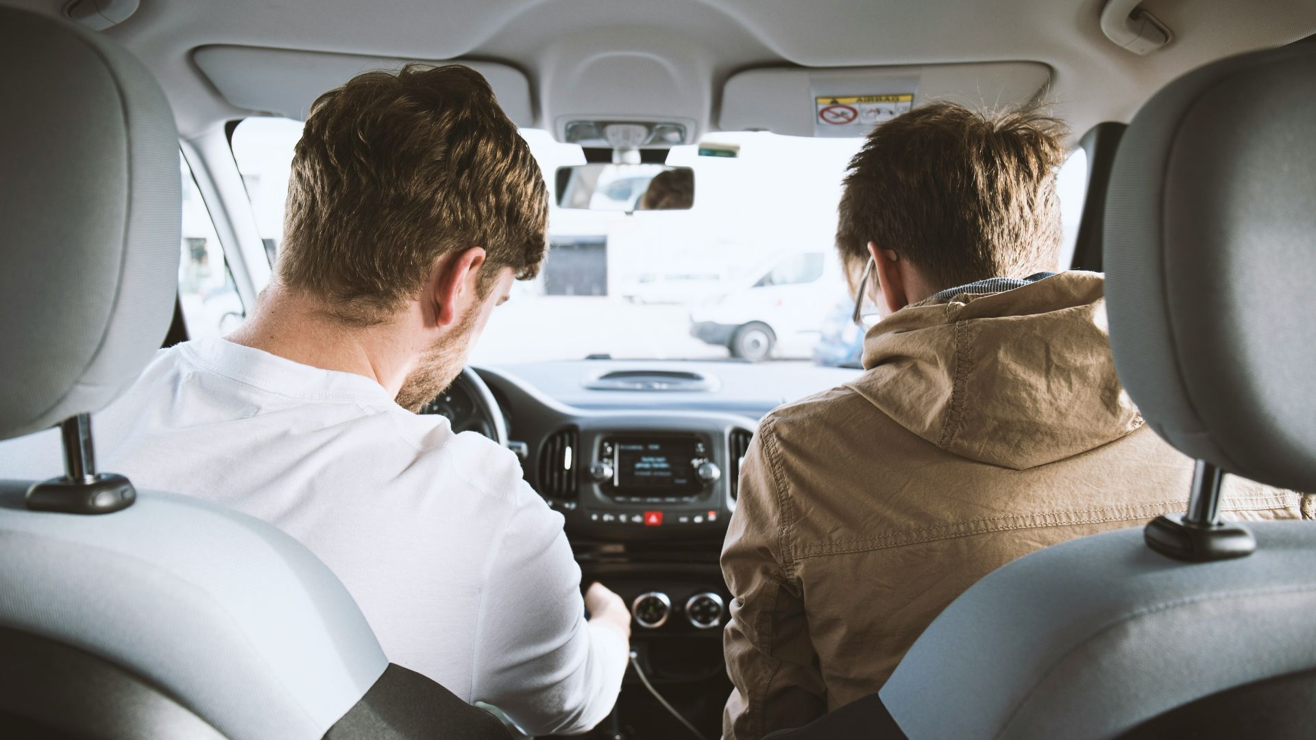 two men sitting inside vehicle