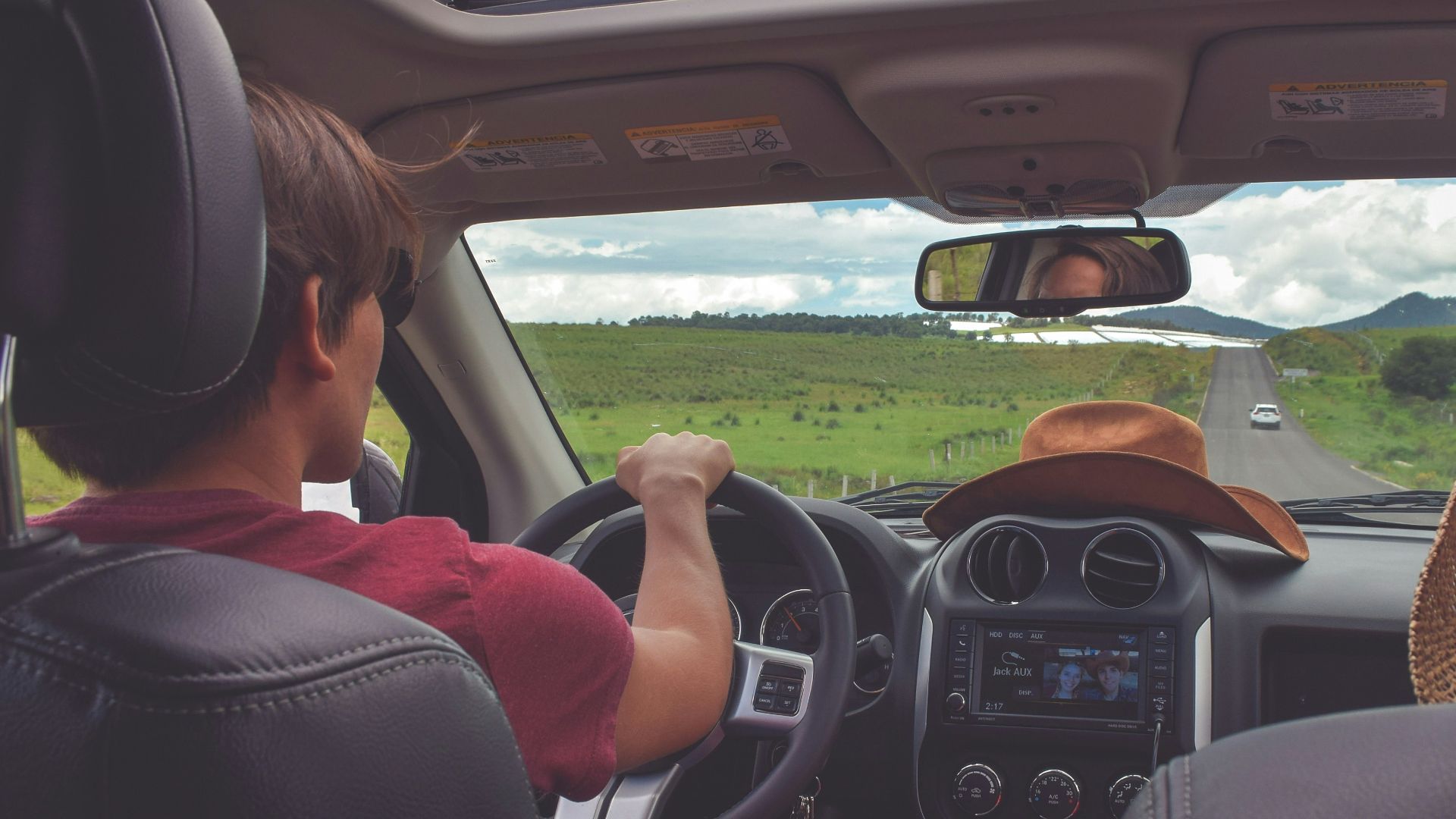 man driving straight on pathway during day time