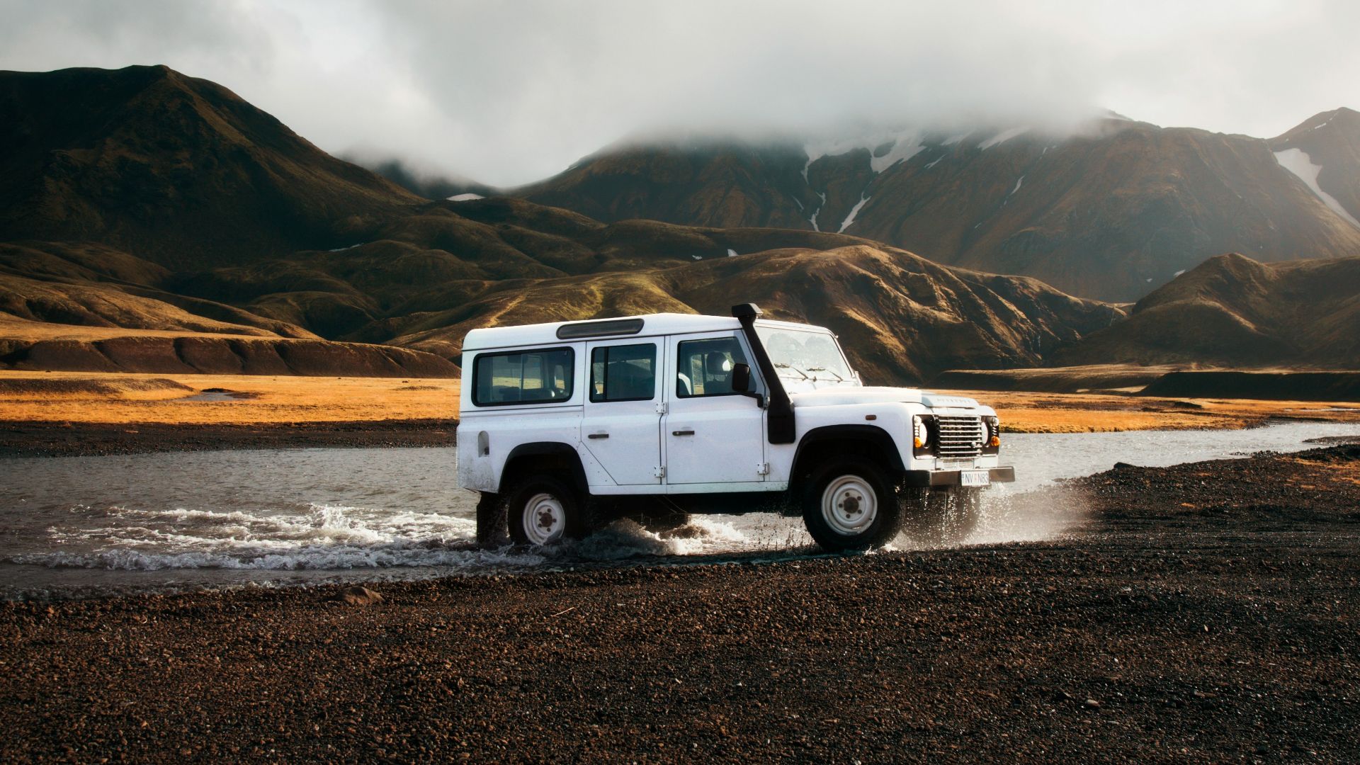 white car crossing body of water