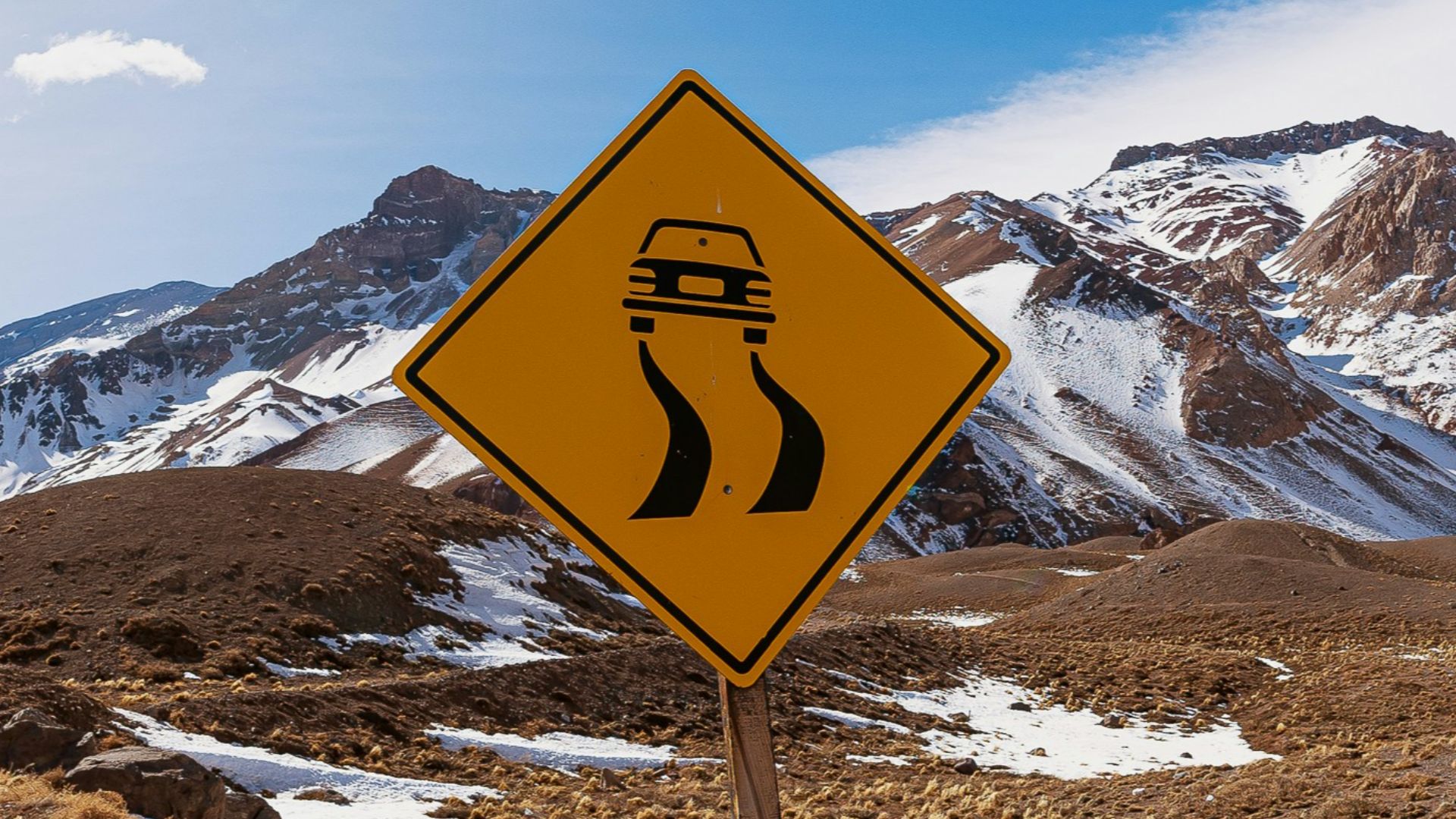 a yellow road sign sitting on the side of a road