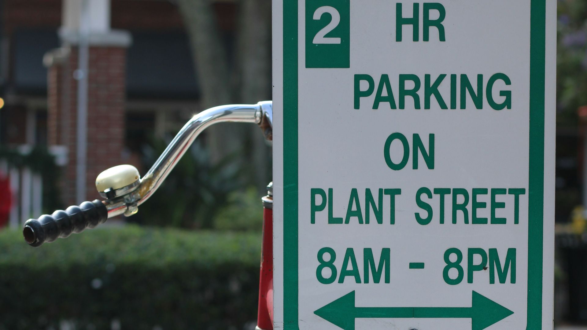 a bicycle is parked next to a sign