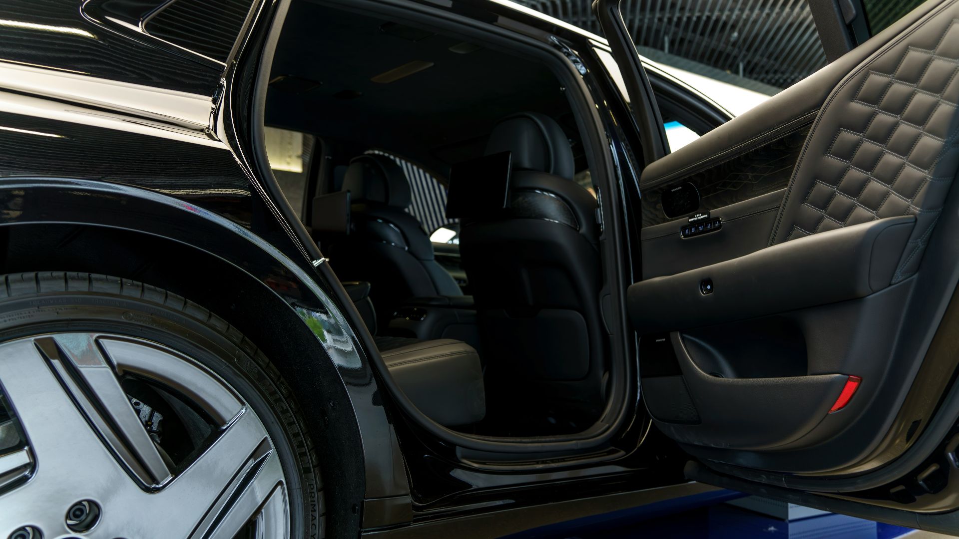 a car with its door open on a showroom floor