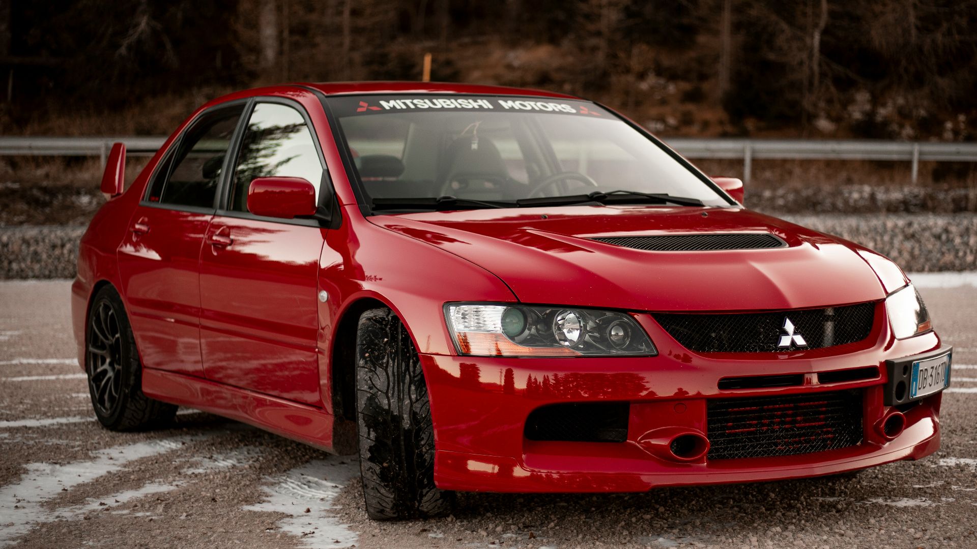 red chevrolet camaro on road during daytime