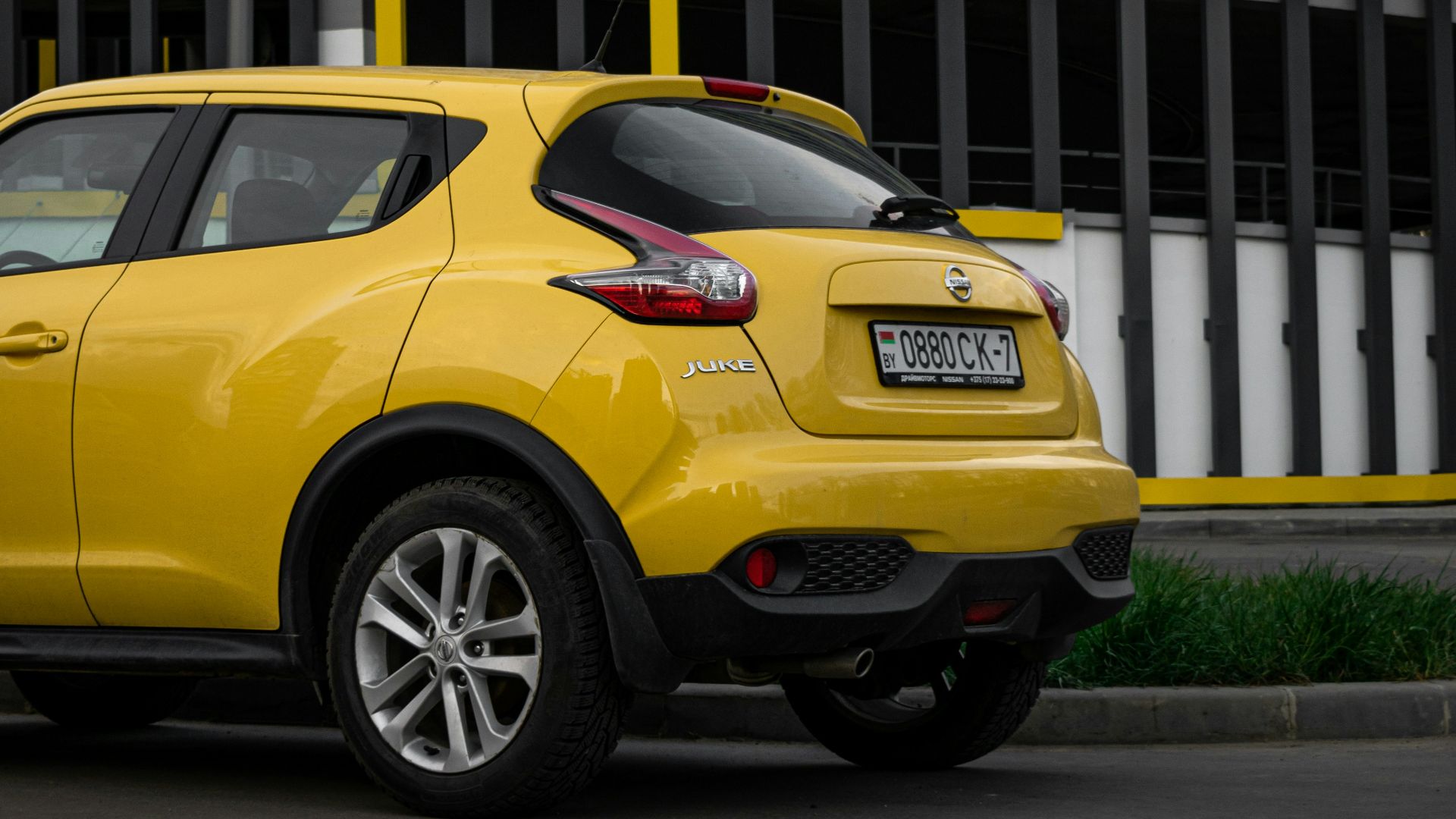 yellow mercedes benz c class parked on roadside during daytime